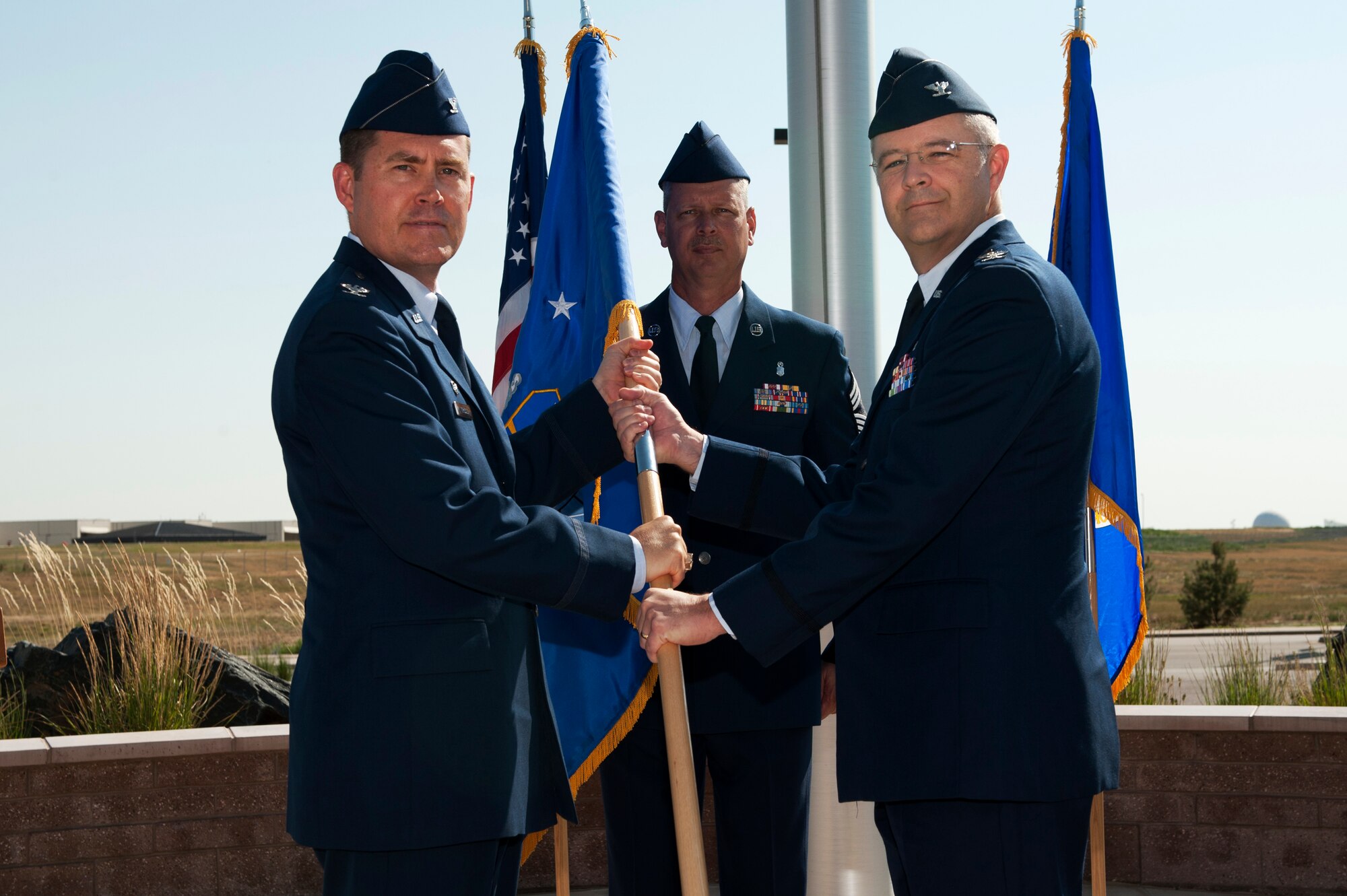 Col. Michael Kindt, 460th Medical Group commander, receives the 460th MDG guidon from Col. Daniel Wright, 460th Space Wing commander, during the 460th MDG change of command ceremony July 11, 2013, on Buckley Air Force Base, Colo. Kindt previously served as the deputy director of medical services at Air Force Medical Operations Agency, Lackland Air Force Base, Texas. (U.S. Air Force photo by Senior Airman Phillip Houk/Released)