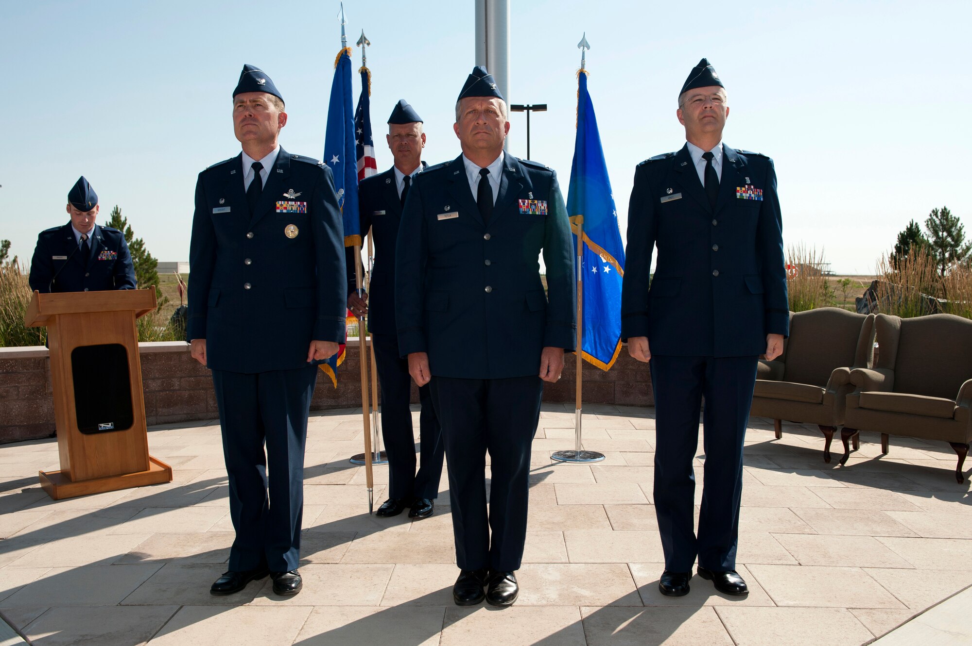 From left to right Col. Dan Wright, 460th Space Wing commander; Col. Robert Tetla, former 460th Medical Group commander; and Col. Michael Kindt, 460th MGD commander; prepare for the 460th MDG change of command ceremony guidon passing July 11, 2013, on Buckley Air Force Base, Colo. This event signified the end of Tetla’s three-year command of the 460th MDG. (U.S. Air Force photo by Senior Airman Phillip Houk/Released)