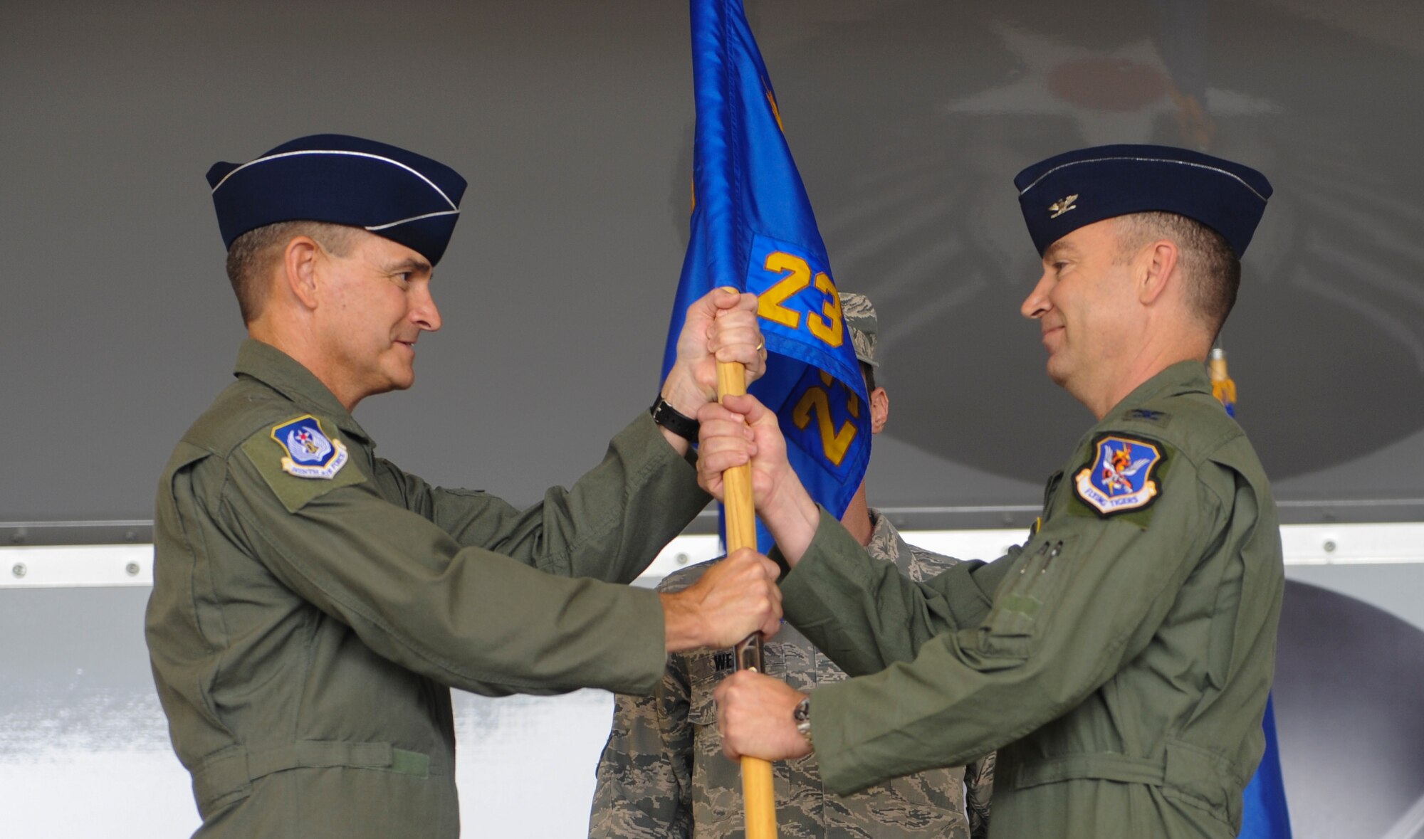 U.S. Air Force Maj. Gen. H.D. Polumbo, 9th Air Force commander, presents Col. Chad Franks, incoming 23d Wing commander, with the 23d Wing guidon at Moody Air Force Base, Ga., July 12, 2013. Franks was the Air Force Central Command chief of staff, forward, Combined Air and Space Operations Center, before becoming the 23d Wing commander at Moody. (U.S. Air Force photo by Airman Alexis Grotz/Released)