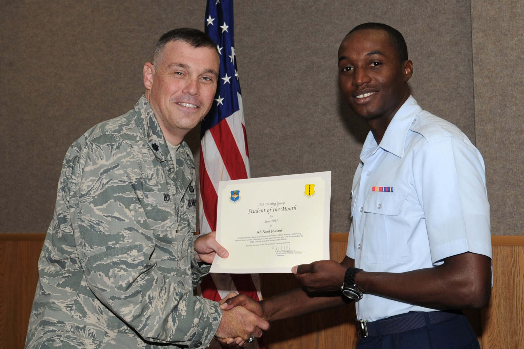 GOODFELLOW AIR FORCE BASE, Texas -- Lt. Col. Edward Blitt, 17th Training Group deputy commander, presents the 312th Training Squadron Student of the Month award for June to Airman Jodson Noel, July 12. (U.S. Air Force photo by Staff Sgt. Laura R. McFarlane)