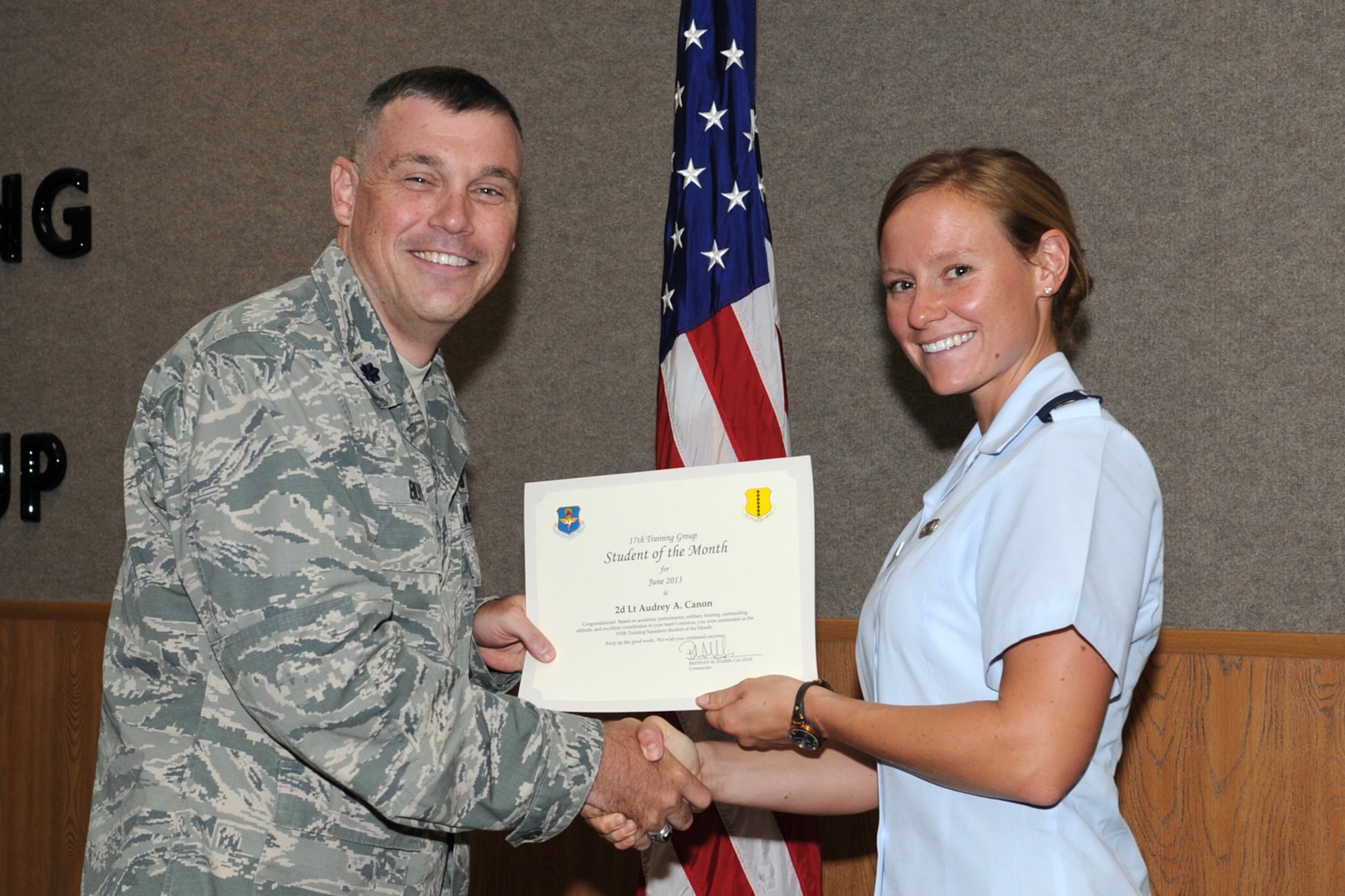 GOODFELLOW AIR FORCE BASE, Texas -- Lt. Col. Edward Blitt, 17th Training Group deputy commander, presents the 315th Training Squadron Officer Student of the Month award for June to 2nd Lt. Audrey Canon, July 12. (U.S. Air Force photo by Staff Sgt. Laura R. McFarlane)