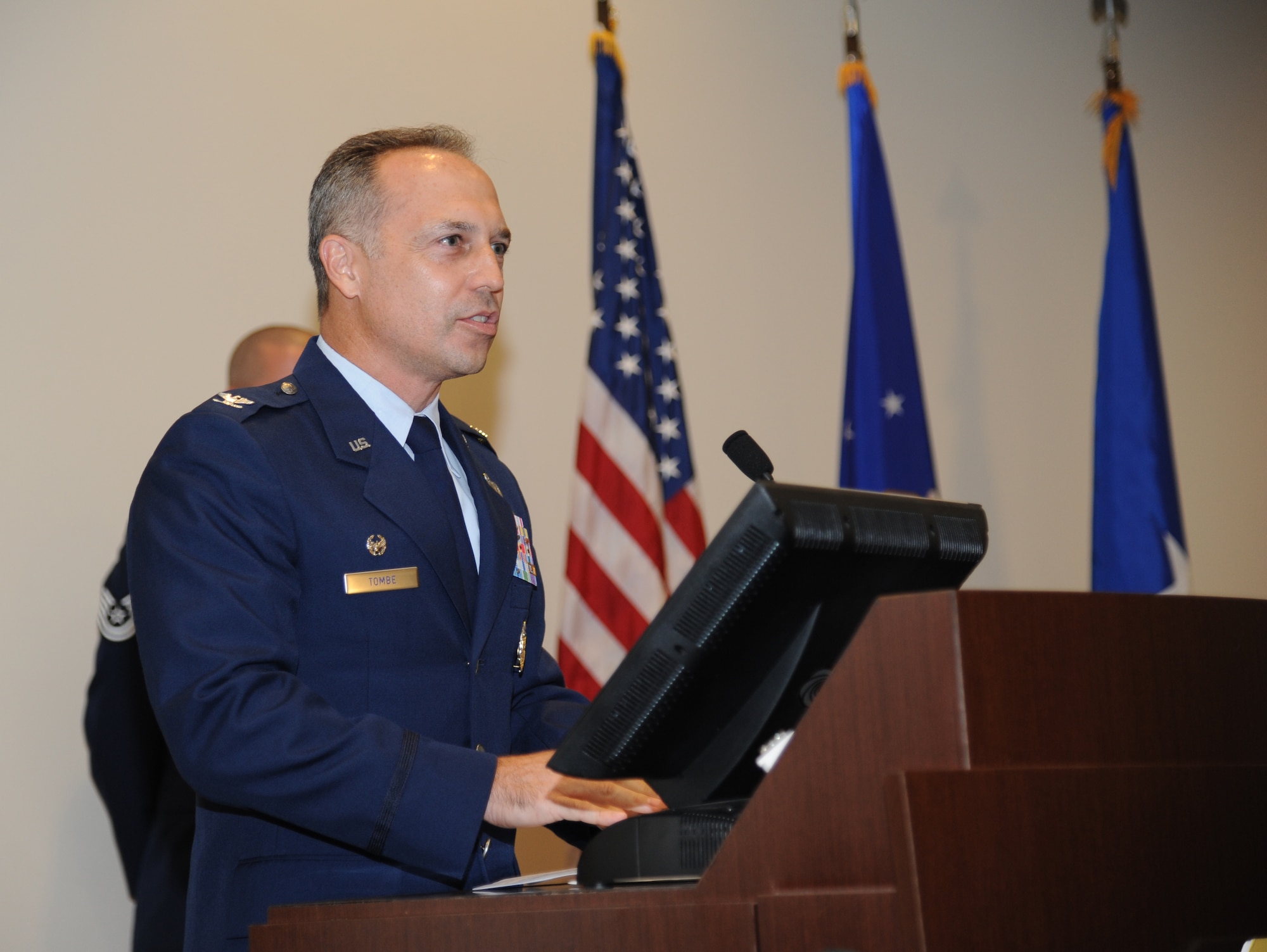 Col. George Tombe, incoming 81st Training Group commander, delivers remarks during the 81st TRG change of command ceremony July 11, 2013, at the Roberts Consolidated Aircraft Maintenance Facility, Keesler Air Force Base, Miss.   Brig. Gen. Brad Spacy, 81st Training Wing commander, was the officiating officer for the event and Col. Maureen Smith was the outgoing 81st TRG commander.  