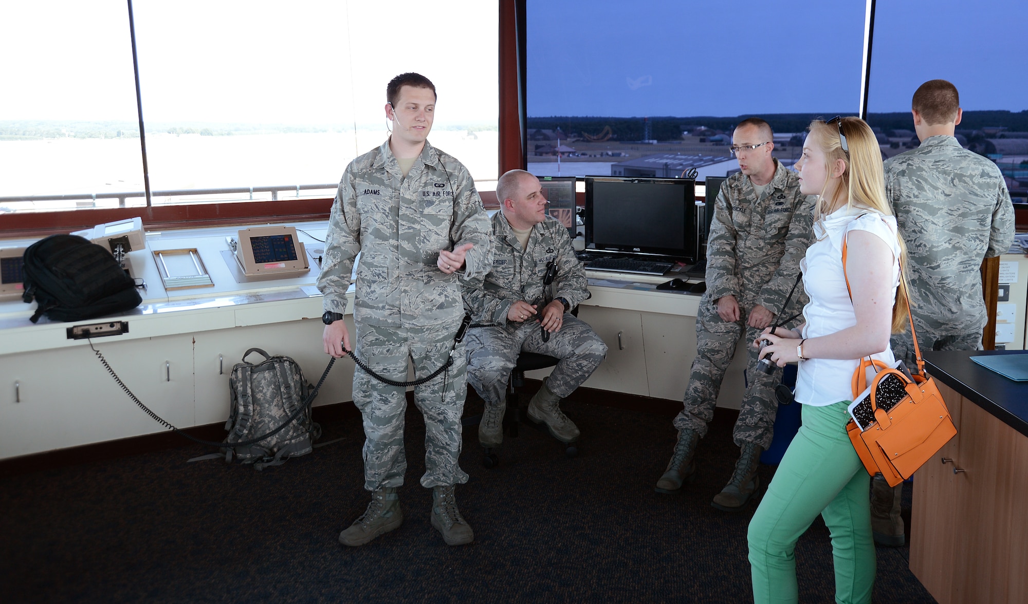 ROYAL AIR FORCE LAKENHEATH, England – Elizabeth Ritsema, 48th Fighter Wing Public Affairs intern, talks to 48th Operations Support Squadron air traffic controllers about their mission July 9, 2013. Ritsema participated in a two-week work experience program to gain more experience in the journalism field. (U.S. Air Force photo by Staff Sgt. Thomas Trower)