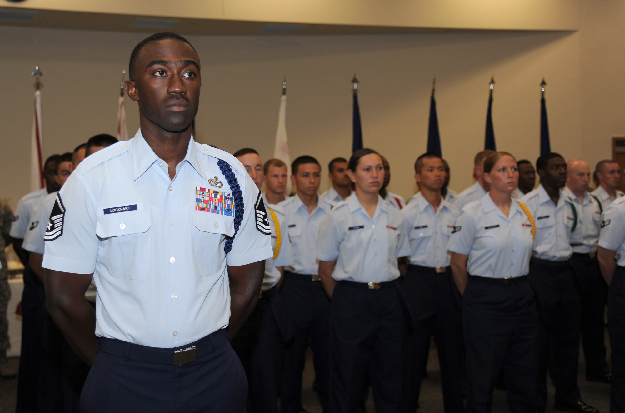Master Sgt. Corey Lockhart, 81st Training Group military training leader, honors the new TRG commander with student Airmen during the 81st TRG change of command ceremony July 11, 2013, at the Roberts Consolidated Aircraft Maintenance Facility, Keesler Air Force Base, Miss.   Brig. Gen. Brad Spacy, 81st Training Wing commander, was the officiating officer for the event as the command was passed from Col. Maureen Smith, outgoing 81st TRG commander, to Col. George Tombe, incoming 81st TRG commander.
