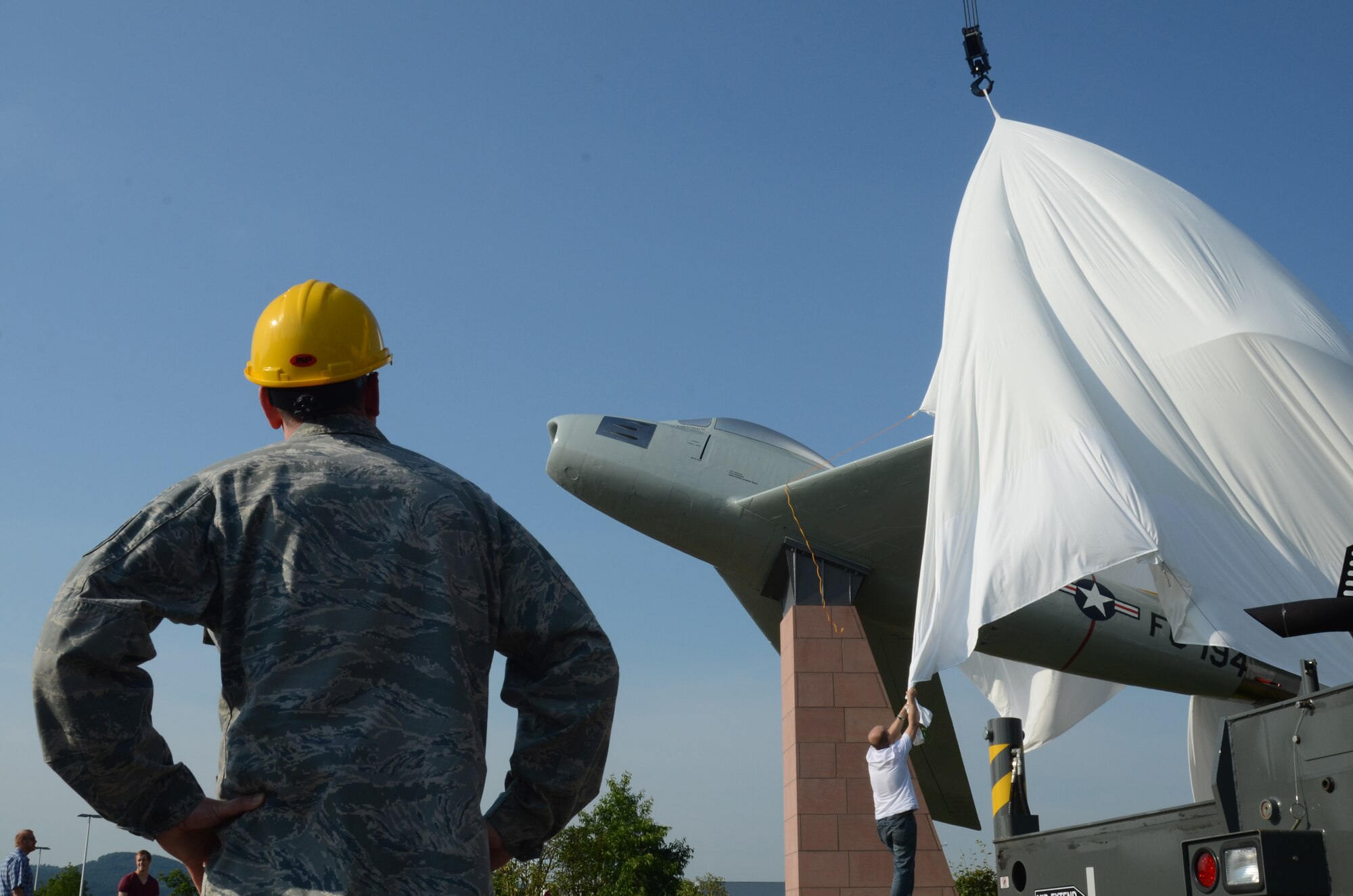 Tech. Sgt. Michael Rhodes, 86th Maintenance Squadron fabrication flight sheet metal NCOIC, watches the unveiling of an F-86 Sabre static display July 9, 2013, Ramstein Air Base, Germany. Rhodes, along with maintenance and civil engineer Airmen, worked on the two-year project in order to exhibit a part of the 86th Airlift Wing’s history to the entire Kaiserslautern Military Community. 

The F-86 is an American fighter jet that was assigned to the 86th Fighter-Bomber Wing in 1953. The aircraft was used against Soviet MiG-15s during dogfights in the Korean War. (U.S. Air Force photo/ 1st Lt. Kay M. Nissen)
