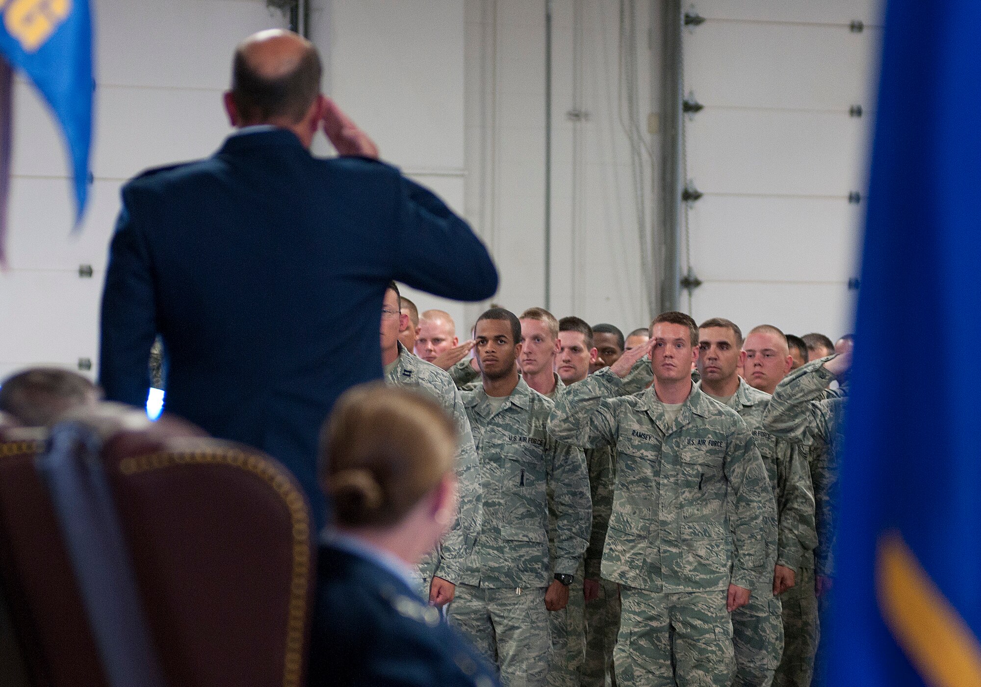 Airmen of the 90th Maintenance Group render their first salute to their new commander, Col. Trevor Flint, during a change-of-command ceremony in the group’s maintenance bays on F. E. Warren Air Force Base, Wednesday, July 3, 2013. (U.S. Air Force photo by R.J. Oriez)
