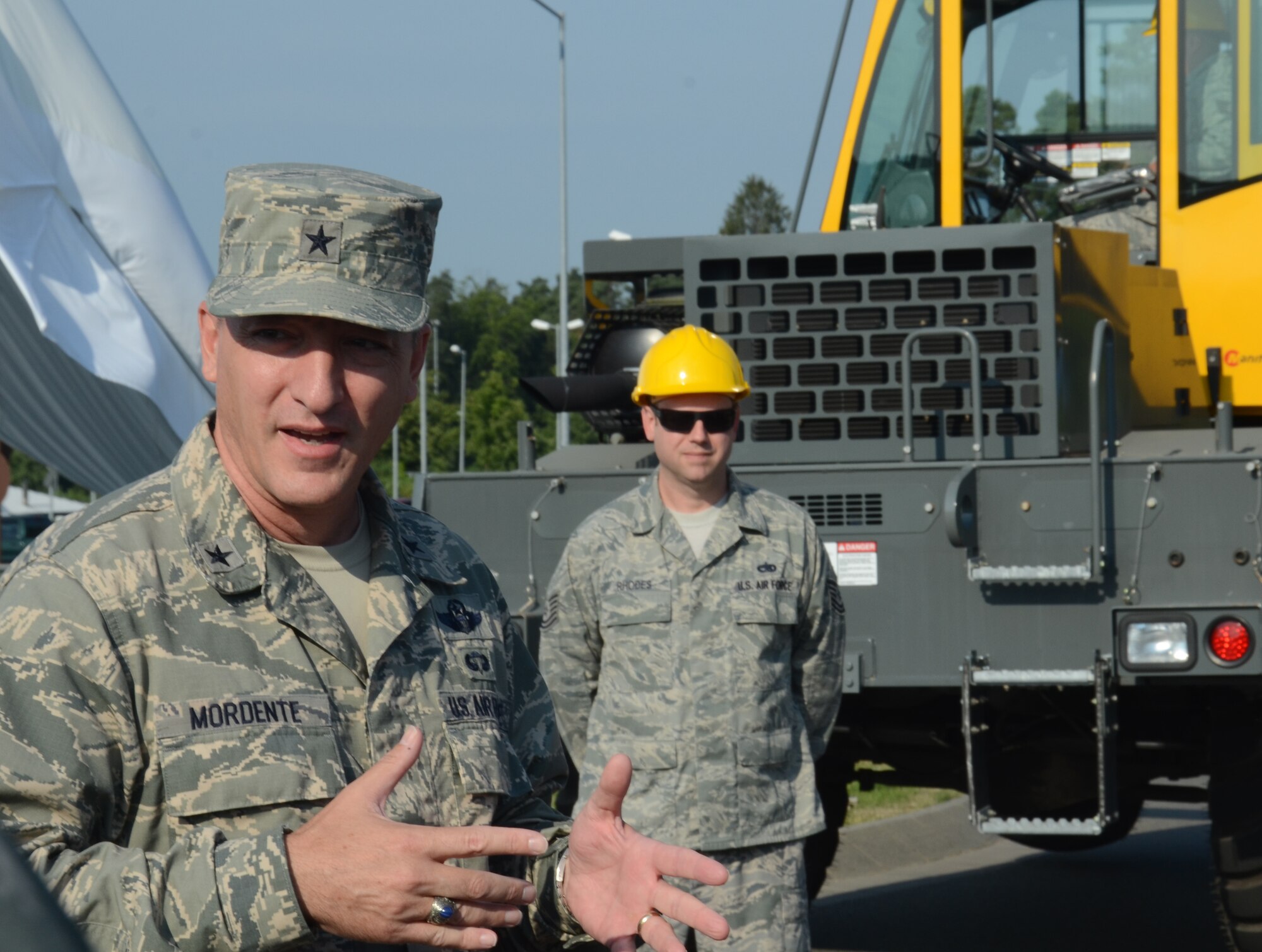 Brig. Gen. Patrick X. Mordente, 86th Airlift Wing commander, speaks to Airmen before the unveiling of an F-86 Sabre static display July 9, 2013, Ramstein Air Base, Germany. The F-86 is an American fighter jet that was assigned to the 86th Fighter-Bomber Wing in 1953.  (U.S. Air Force photo / 1st Lt. Kay M. Nissen)