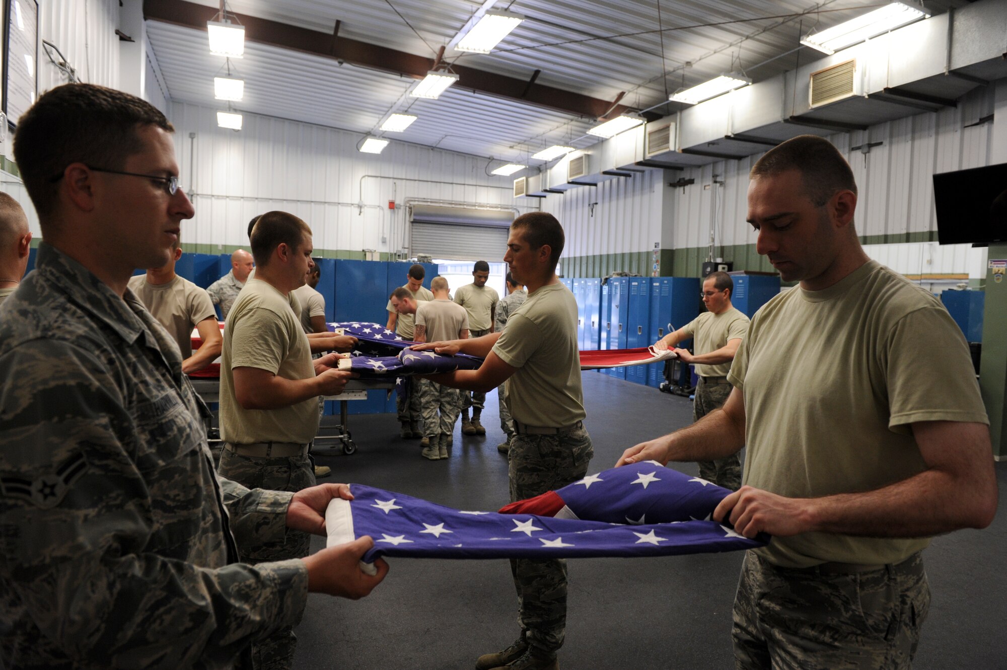 Base honor guardsmen tighten up two-man flag folding techniques and retiree military honors procedures during training May 28, 2013, at Little Rock Air Force Base, Ark. Last year the base honor guard performed in more than 715 military funeral honors. (U.S. Air Force photo by Senior Airman Rusty Frank)