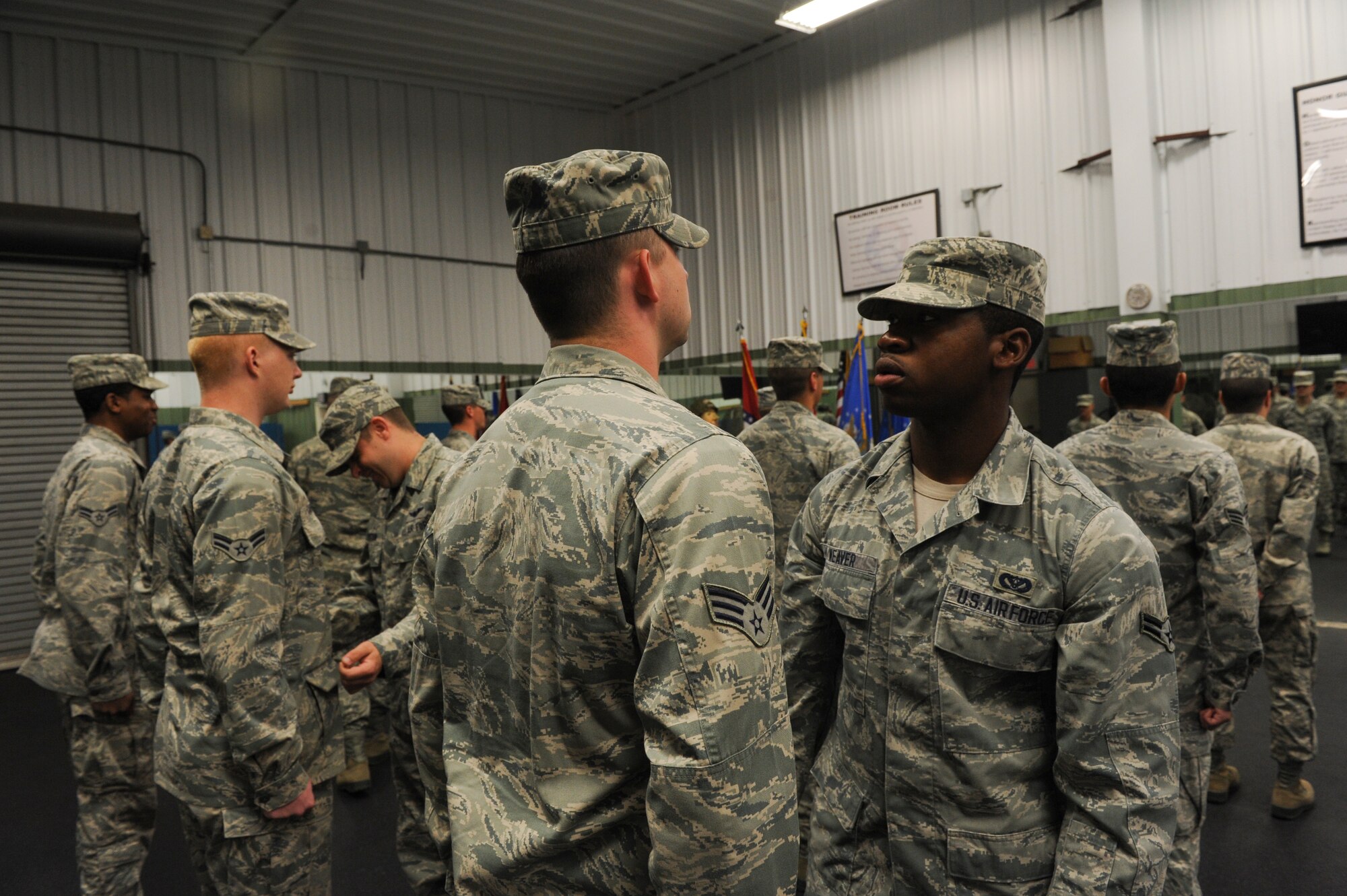 Base honor guard members look over each other’s uniforms during their daily open ranks inspection May 28, 2013, at Little Rock Air Force Base, Ark. Daily inspections ensure their uniforms are serviceable and the standards for dress and appearances are met. (U.S. Air Force photo by Senior Airman Rusty Frank)