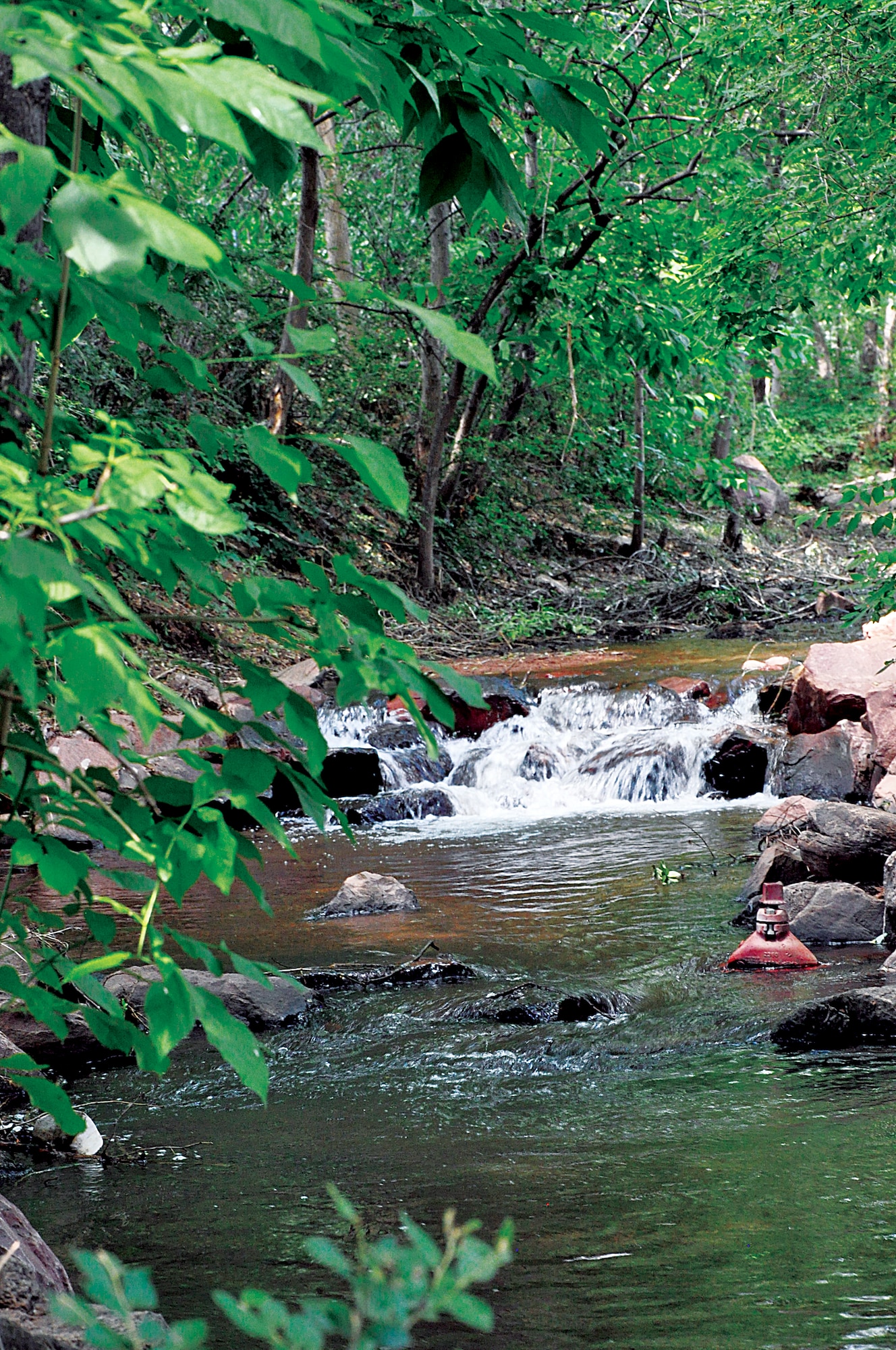 Visitors can take a stroll along a creek while touring Manitou Springs, Colo. Manitou Springs is a tourist town with features such as parks, a penny arcade and the cog railway, and it is at the base of Garden of the Gods. (U.S. Air Force photo by Airman 1st Class Brandon Valle)