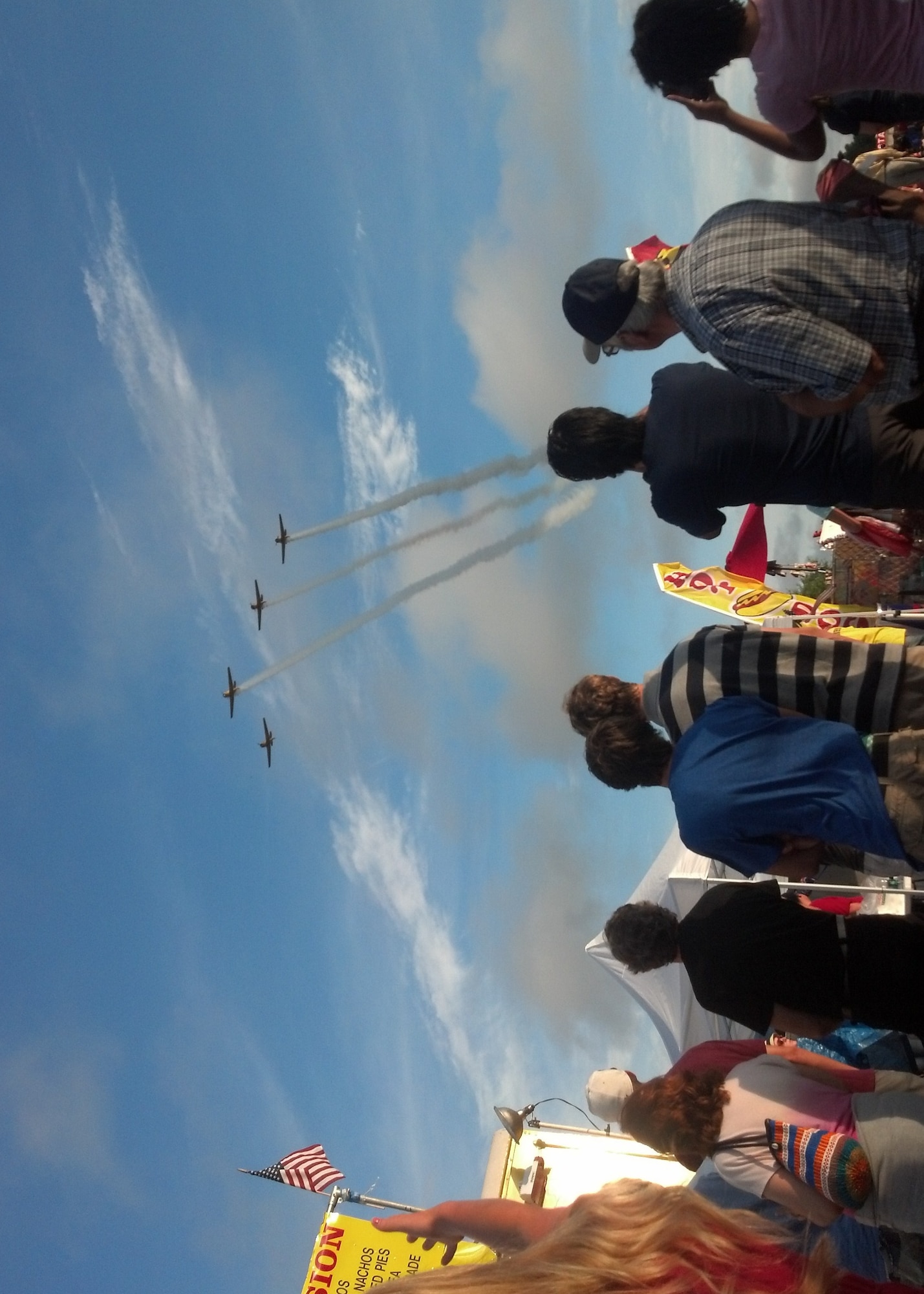Spectators watch as a formation of four T-6 Texan’s fly overhead at the Fireworks on the Water event July 4 at the Stennis Lock and Dam. The AT-6 Texan was used to train pilots back in the World War II era. Although the T-6 Texan II is now used for training, the AT-6 Texan remains as a popular airplane for air shows. (U.S. Air Force Photo/ Technical Sgt. Bryan Franks)