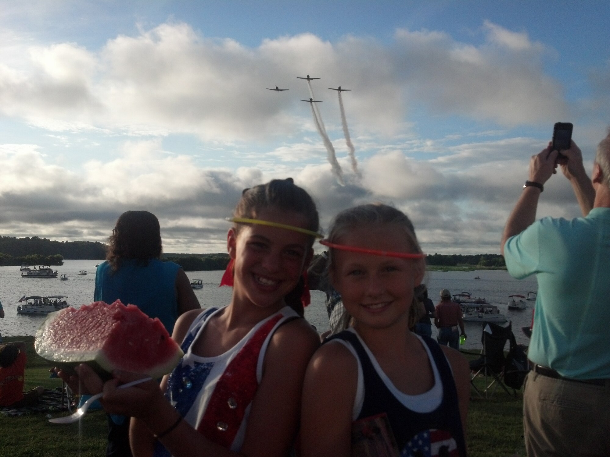 Alyvia Franks and Elizabeth Truelock pose for a photo during the flyover at the Fireworks on the Water event July 4 at the Stennis Lock and Dam. The event provided the perfect setting to enjoy America’s independence with friends and family members. (U.S. Air Force Photo/ Technical Sgt. Bryan Franks)