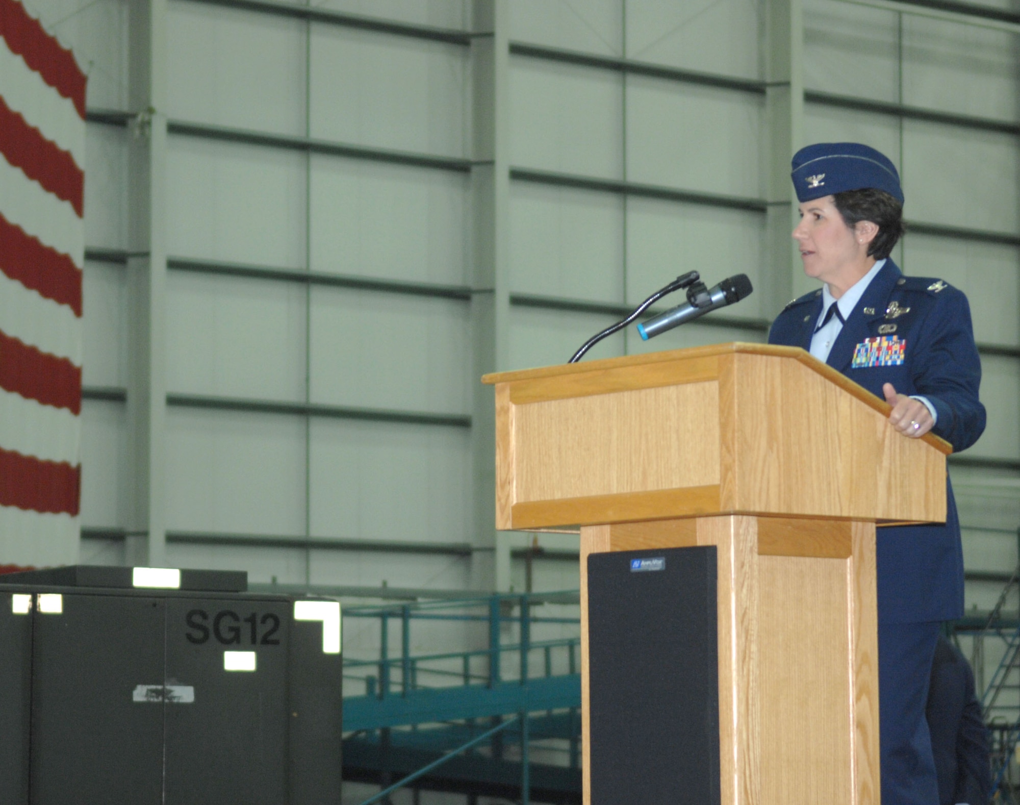 Col. Nancy Bozzer, 100th Operations Group commander, speaks during the 100th Operations Support Squadron change of command July 12, 2013, in Hanger 814 on RAF Mildenhall, England. Bozzer acted as the presiding official over the change of command. (U.S. Air Force photo by Airman 1st Class Dillon Johnston/Released)
