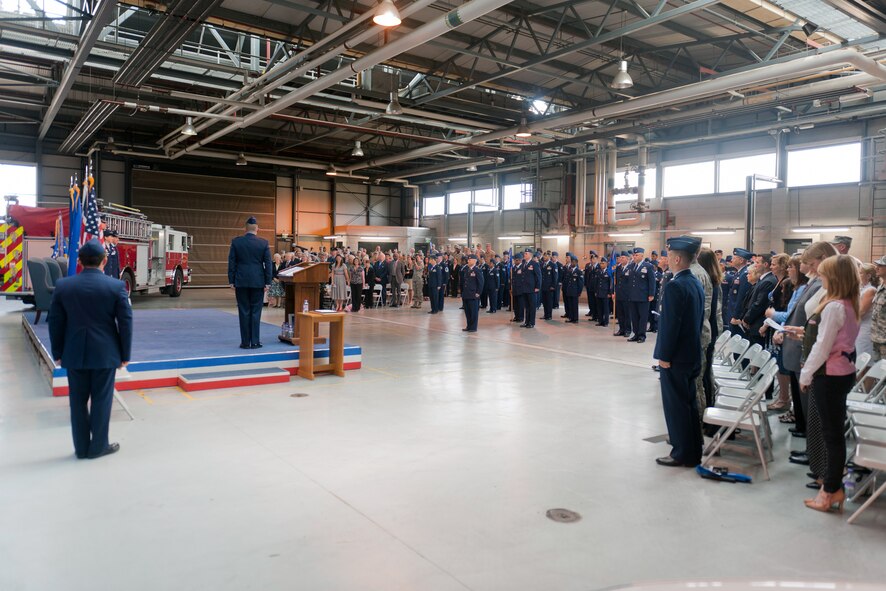RAF ALCONBURY, United Kingdom - Members of the 501st Combat Support Wing stand during the playing of the Air Force Song after the 501st CSW change of command ceremony at the RAF Alconbury Fire Department July 12. Col. Angela Cadwell assumed command of the 501st CSW from Col. Brian Kelly during the ceremony. (U.S. Air Force photo by Staff Sgt. Brian Stives)
