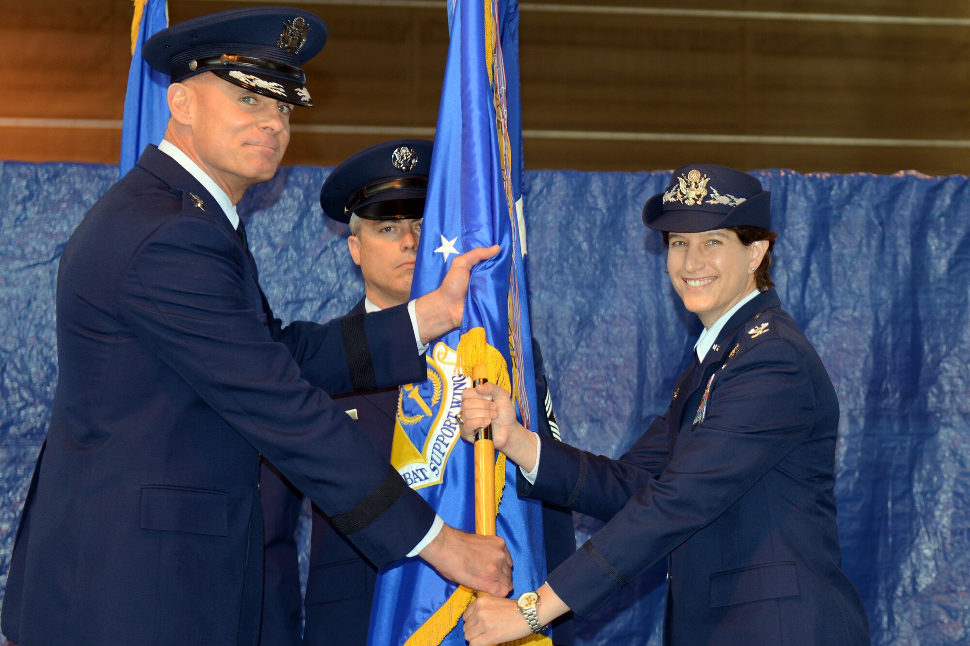 RAF ALCONBURY, United Kingdom - Col. Angela Cadwell accepts the501st Combat Support Wing guidon from Lt. Gen. Craig Franklin, 3rd Air Force commander, after assuming command of the wing during a change of command ceremony at the RAF Alconbury Fire Department July 12. (U.S. Air Force photo by Tech. Sgt. Chrissy Best)