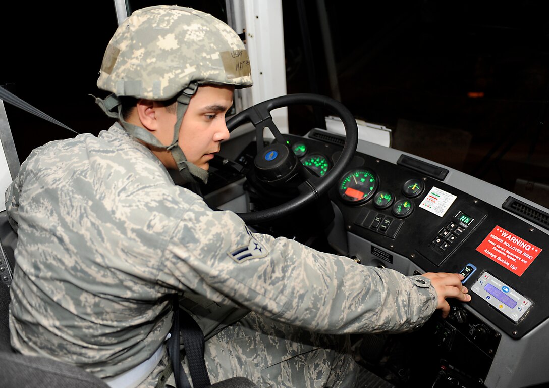 Airman 1st Class Matthew Sinnemaki, 28th Logistics Readiness Squadron vehicle operator, presses the door release on a shuttle while making a stop at the 28th Bomb Wing Headquarters during a Phase II operational readiness exercise at Ellsworth Air Force Base, S.D., July 12, 2013. Sinnemaki and other vehicle operators transported exercise participants to and from the Pride Hangar and other locations across the simulated deployed environment. (U.S. Air Force photo by Airman 1st Class Ashley J. Thum/Released)