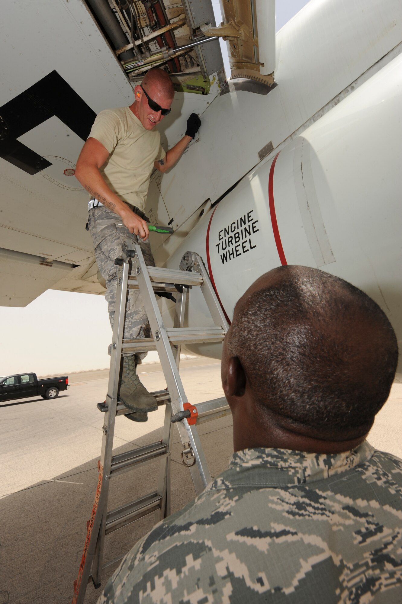 U.S. Air Force Chaplain (Capt.) Winston Jones, 380th Air Expeditionary Wing, talks with U.S. Air Force Staff Sgt. Jeffrey Bauer, 380th Expeditionary Aircraft Maintenance Squadron E-3 Sentry crew chief, during a visit to the flightline at an undisclosed location in Southwest Asia July 9, 2013. Jones is the maintenance and operation group's chaplain and visits Airmen on the flight line multiple times a week. Jones hails from Detroit, Mich., and is deployed from Joint Base Charleston, S.C. Bauer is native to St. Louis, Mo., and is deployed from Tinker Air Force Base, Okla. (U.S. Air Force photo by Staff Sgt. Joshua J. Garcia)