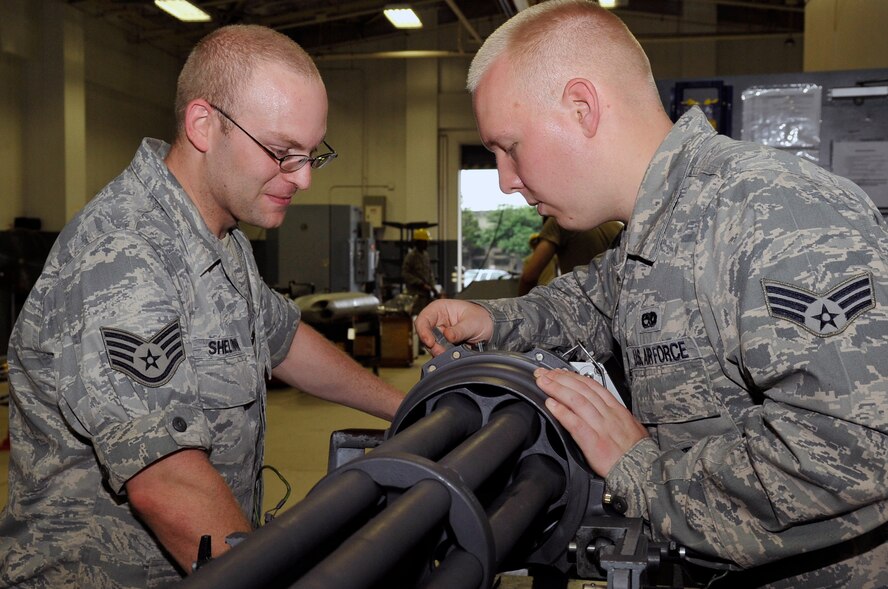 U.S. Air Force Staff Sgt. Dan Sheltrown, 35th Maintenance Squadron aircraft armament  craftsman, and Senior Airman Tyler Scoville, 35 MXS  aircraft armament journeyman, use a go no go gauge to measure the gap between the ammunition and the firing pin on a gattling gun at Misawa Air Base, Japan, July 11, 2013. The gun fires high explosive-incendiary 20mm bullets at a rate of 100 rounds per second. (U.S. Air Force photo by Airman 1st Class Zachary Kee)