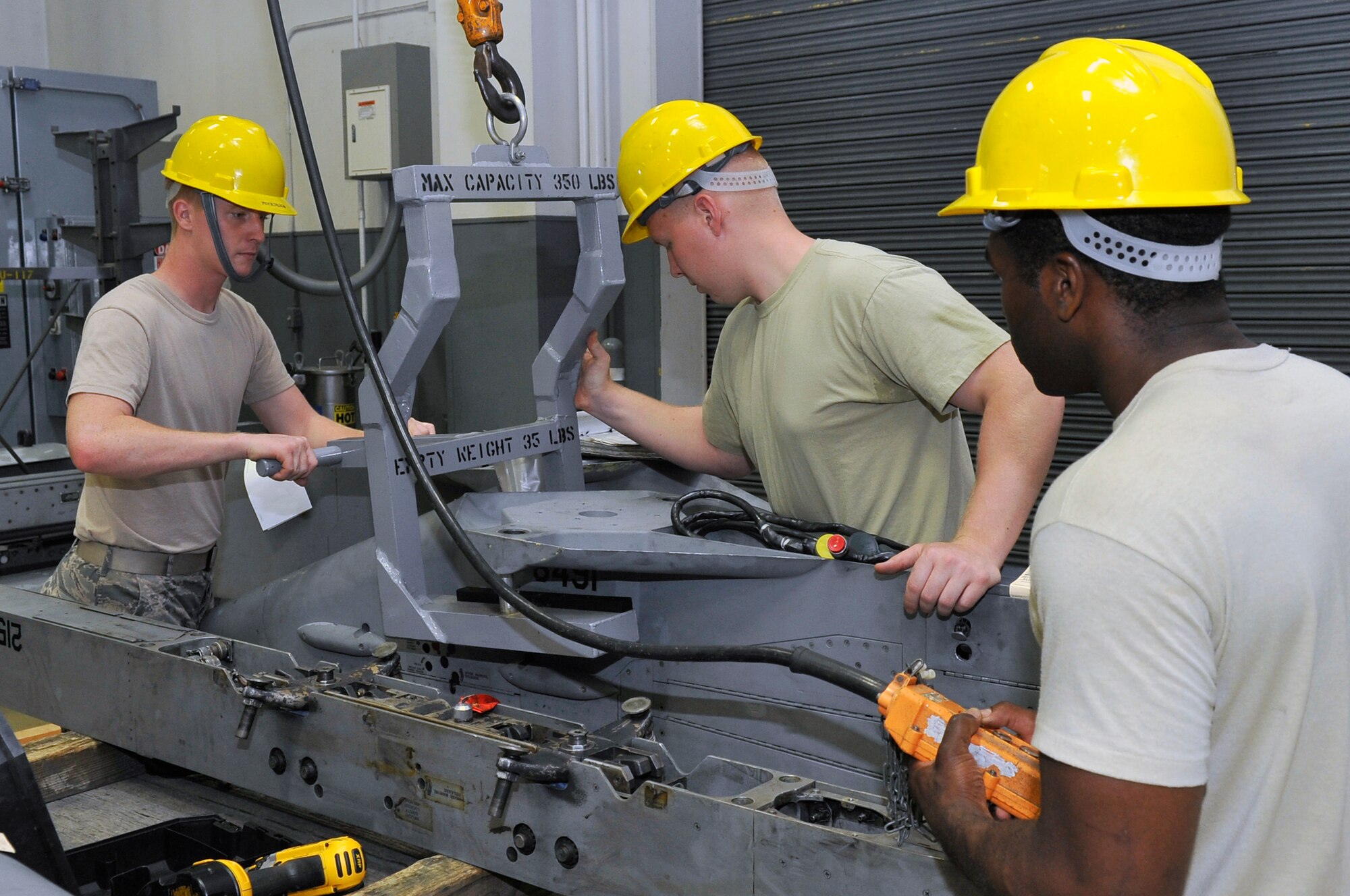 Airmen from the 35th Maintenance Squadron armament flight move a wings weapon pylon at Misawa Air Base, Japan, July 11, 2013. Airmen in the 35 MXS armament flight provide safe, reliable aircraft, equipment and munitions to train F-16 Fighting Falcon pilots and crew chiefs. (U.S. Air Force photo by Airman 1st Class Zachary Kee)