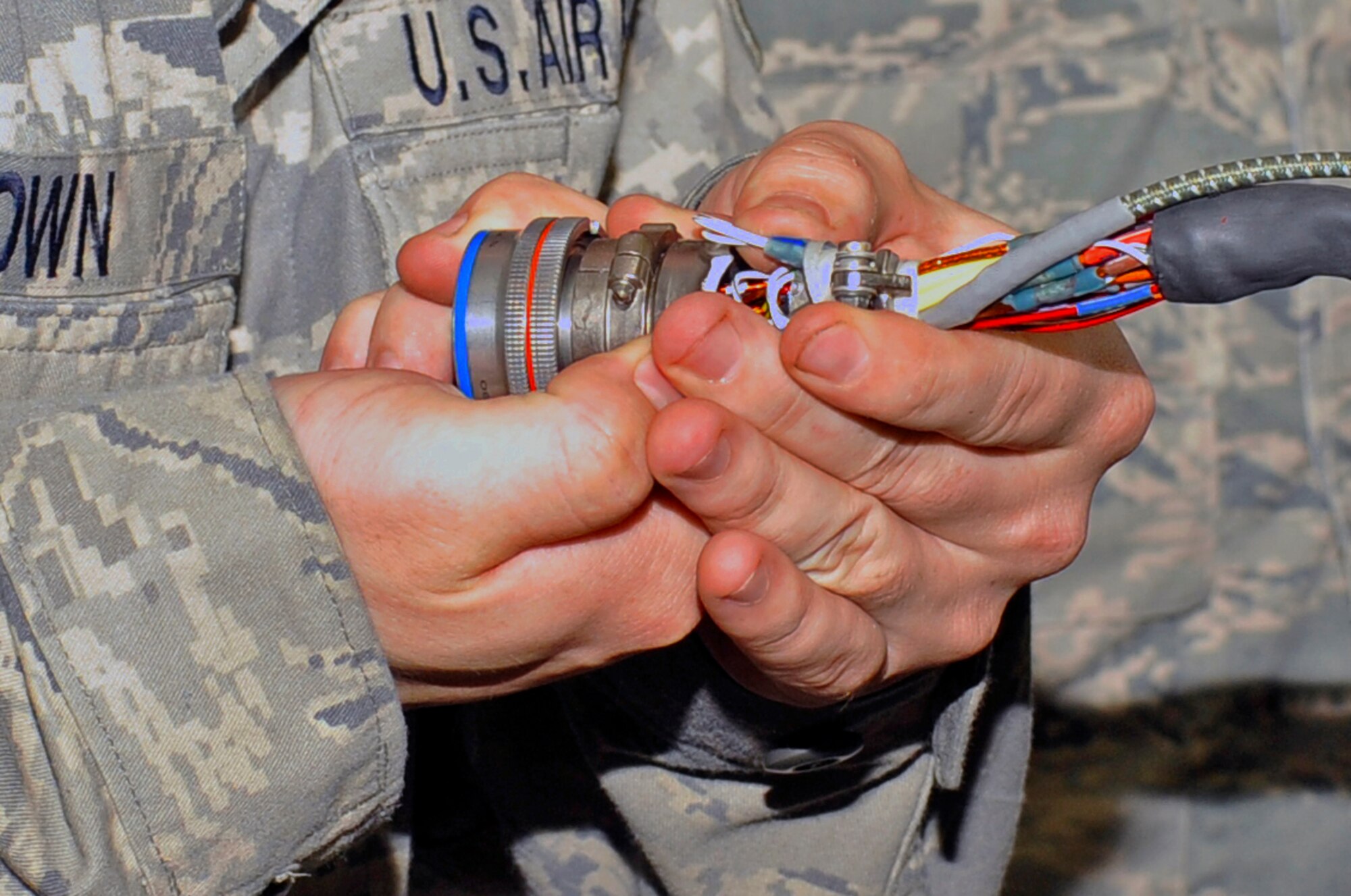 U.S. Air Force Staff Sgt. Travis Brown, 35th Maintenance Squadron aircraft armament craftsman, repins a video connector on a launcher air unit at Misawa Air Base, Japan, July 11, 2013. The mission of the 35 MXS armament flight is to provide the 35th Fighter Wing with highly reliable combat ready armament systems. (U.S. Air Force photo by Airman 1st Class Zachary Kee)