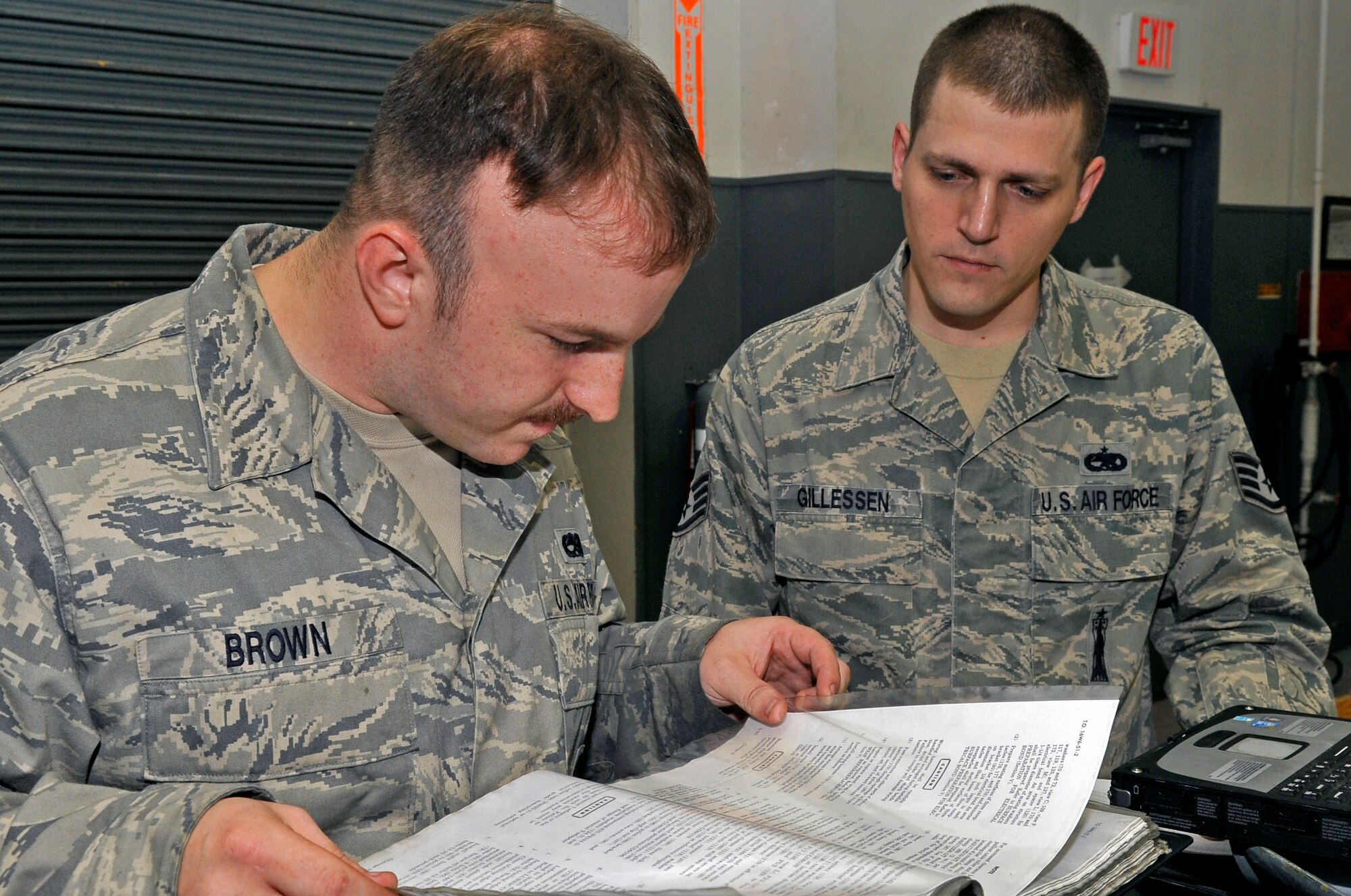 U.S. Air Force Staff Sgt. Travis Brown, left, 35th Maintenance Squadron aircraft armament craftsman, reads a manual while Staff Sgt. Charles Gillessen, 35th MXS quality assurance inspector, inspects his performance while repining a video connector on a launcher air unit at Misawa Air Base, Japan, July 11, 2013. The 35 MXS armament flight holds strict quality assurance standards such as the use of manuals to help prevent potential mistakes. (U.S. Air Force photo by Airman 1st Class Zachary Kee)