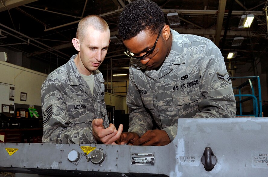 U.S. Air Force Tech. Sgt. Cory Mersino, left, 35th Maintenance Squadron armament flight section supervisor, inspects the safety wiring applied by Airman 1st Class Jerrion Roque, 35 MXS aircraft armament journeyman, at Misawa Air Base, Japan, July 11, 2013. Pre-maintenance inspections provide safe and reliable equipment for training and real-world taskings of F-16 Fighting Falcons. (U.S. Air Force photo by Airman 1st Class Zachary Kee)