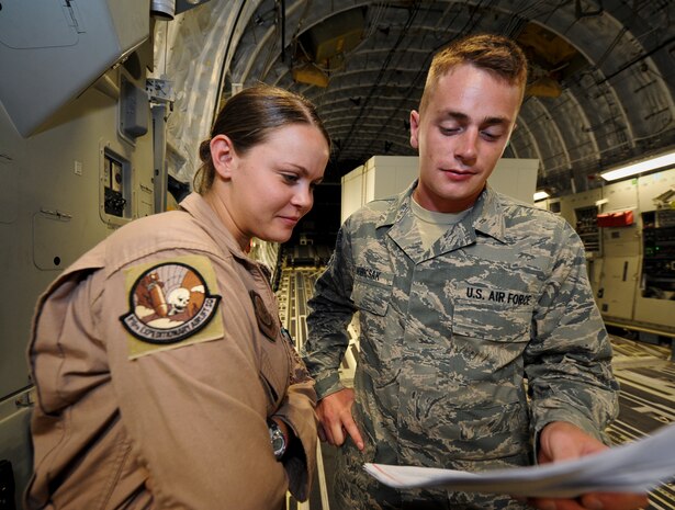 Staff Sgt. John Hubicsak discusses load plans with Airman 1st Class Brittany McGarrity on a C-17 Globemaster III at the 379th Air Expeditionary Wing in Southwest Asia, July 12, 2013. Hubicsak is an 8th Expeditionary Air Mobility Squadron air terminal operations center information controller deployed from Ramstein Air Base, Germany, and McGarrity is an 816th Expeditionary Airlift Squadron C-17 loadmaster deployed from Joint Base Charleston, S.C. (U.S. Air Force photo/Senior Airman Benjamin Stratton)