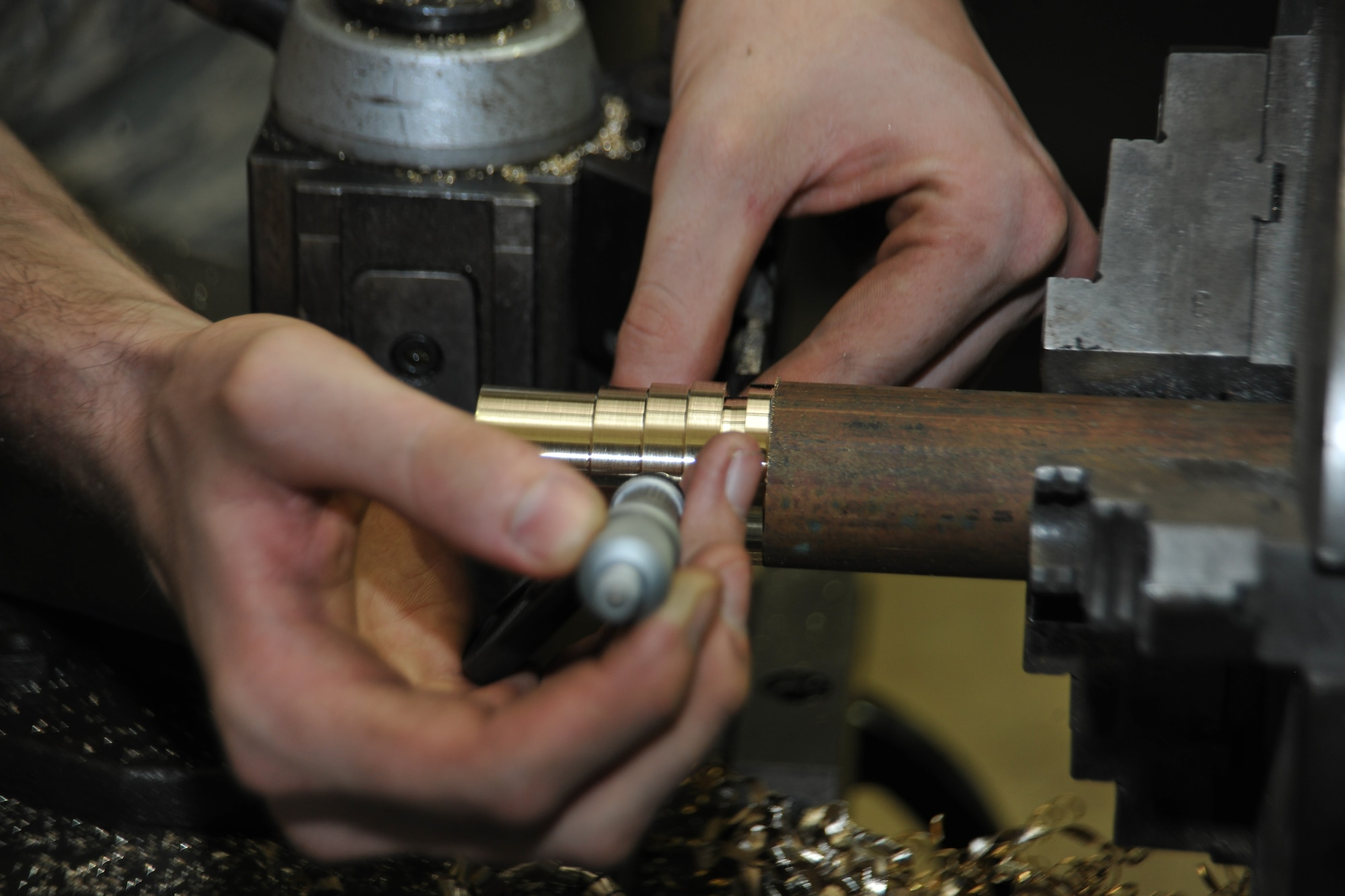 Staff Sgt. Jeremy Flint, 36th Maintenance Squadron Metals Technology Section NCO in charge, works on a lathe to manufacture aircraft components July 10, 2013, on Andersen Air Force Base, Guam. The metal technology section provides welding, precision measurement and machining to aircraft components and aircraft ground equipment.  (U.S. Air Force photo by Senior Airman Robert Hicks/Released)