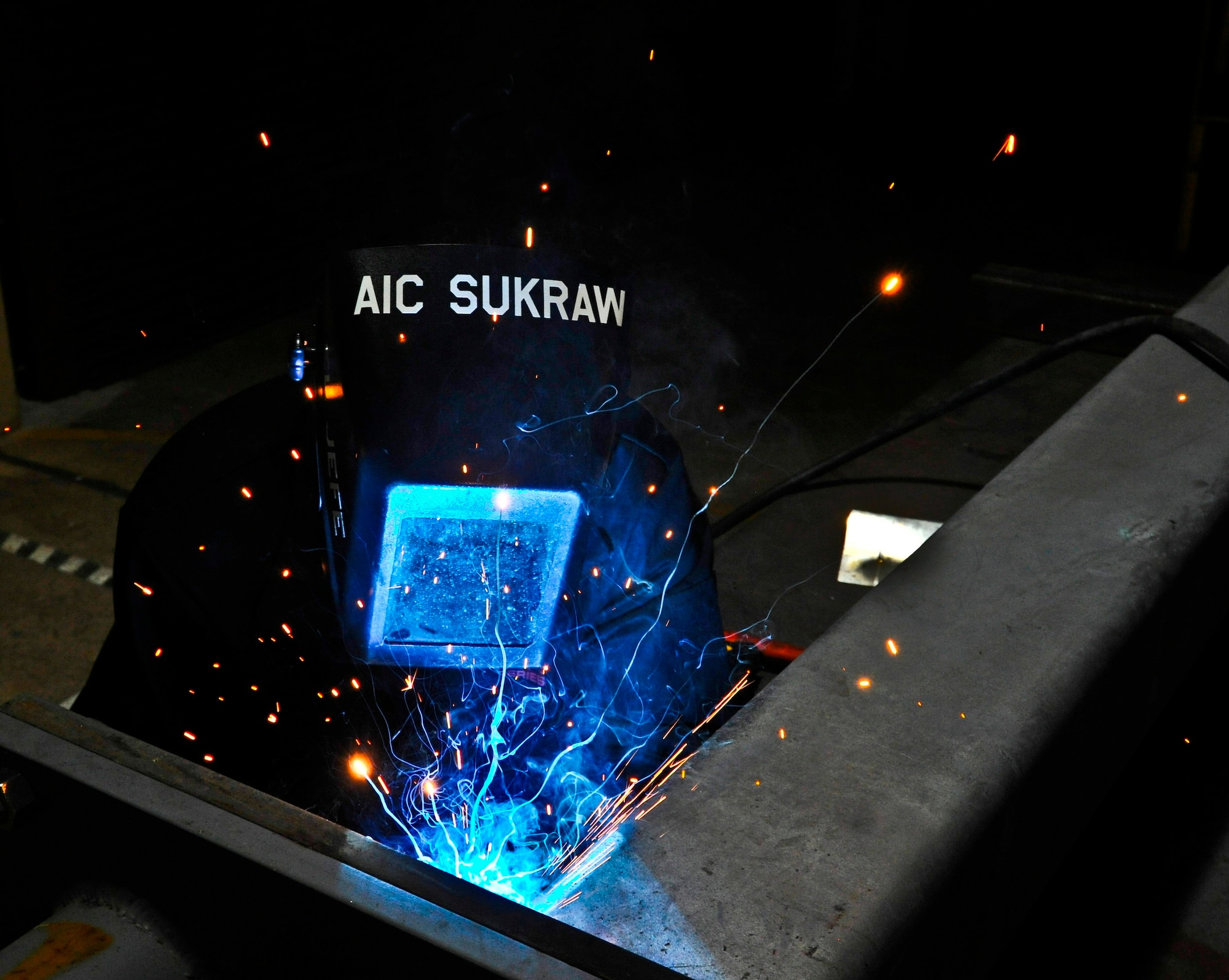 Airman 1st Class Jeff Sukraw, 36th Maintenance Squadron metals technology technician, modifies a rotary launch adaptor proof load test stand for a B-52 Stratofortress July 9, 2013, on Andersen Air Force Base, Guam. The proof load test stand, which is the only stand in the Air Force, is used to test the structural integrity of the repaired RLAs. (U.S. Air Force photo by Senior Airman Robert Hicks/Released)