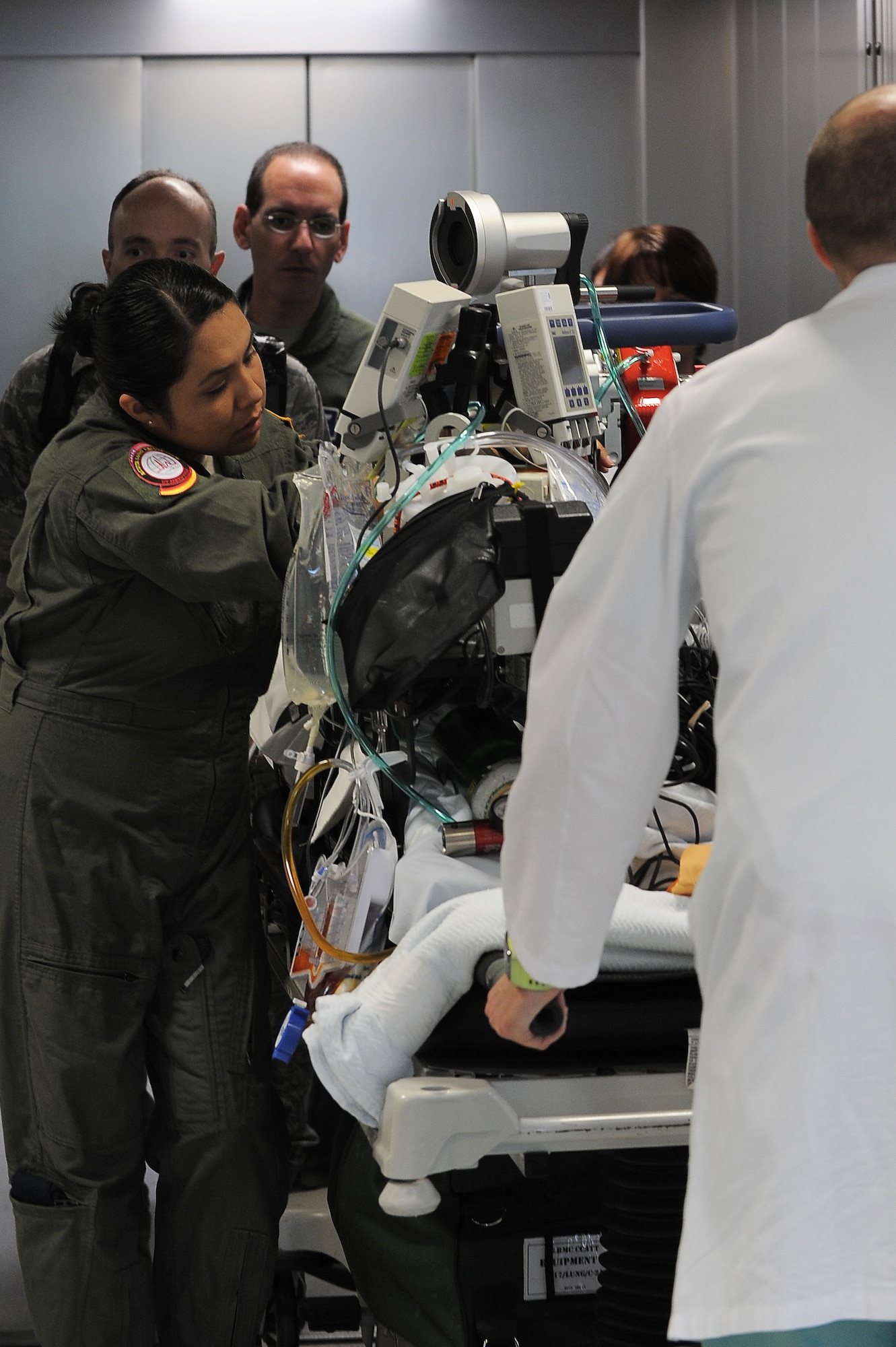 Service members work together to transfer a patient onto a medical bus, July 10, 2013, Landstuhl Regional Medical Center, Germany. An active duty Air Force crew made history while flying specialized medical teams and their patient requiring medical equipment never before used on board a Transatlantic mission. (U.S. Air Force photo/Senior Airman Hailey Haux)