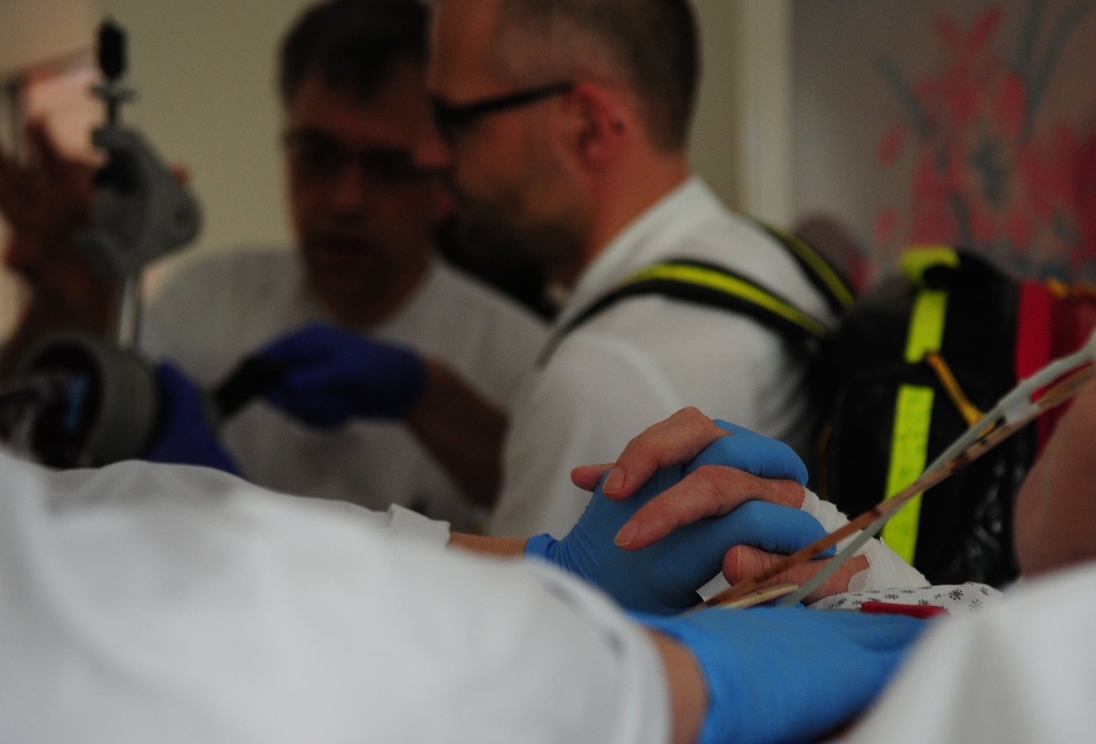 A nurse holds a patients hand while being transferred to the hospital, July 9, 2013, Landstuhl Regional Medical Center, Germany. An active duty Air Force crew made history while flying specialized medical teams and their patient requiring medical equipment never before used on board a Transatlantic mission. (U.S. Air Force photo/Senior Airman Hailey Haux)