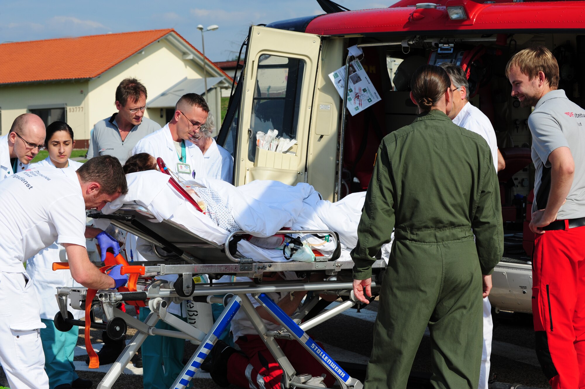 German and American medical personnel transport a patient, July 9, 2013, Landstuhl Regional Medical Center, Germany. An active duty Air Force crew made history while flying specialized medical teams and their patient requiring medical equipment never before used on board a Transatlantic mission. (U.S. Air Force photo/Senior Airman Hailey Haux)