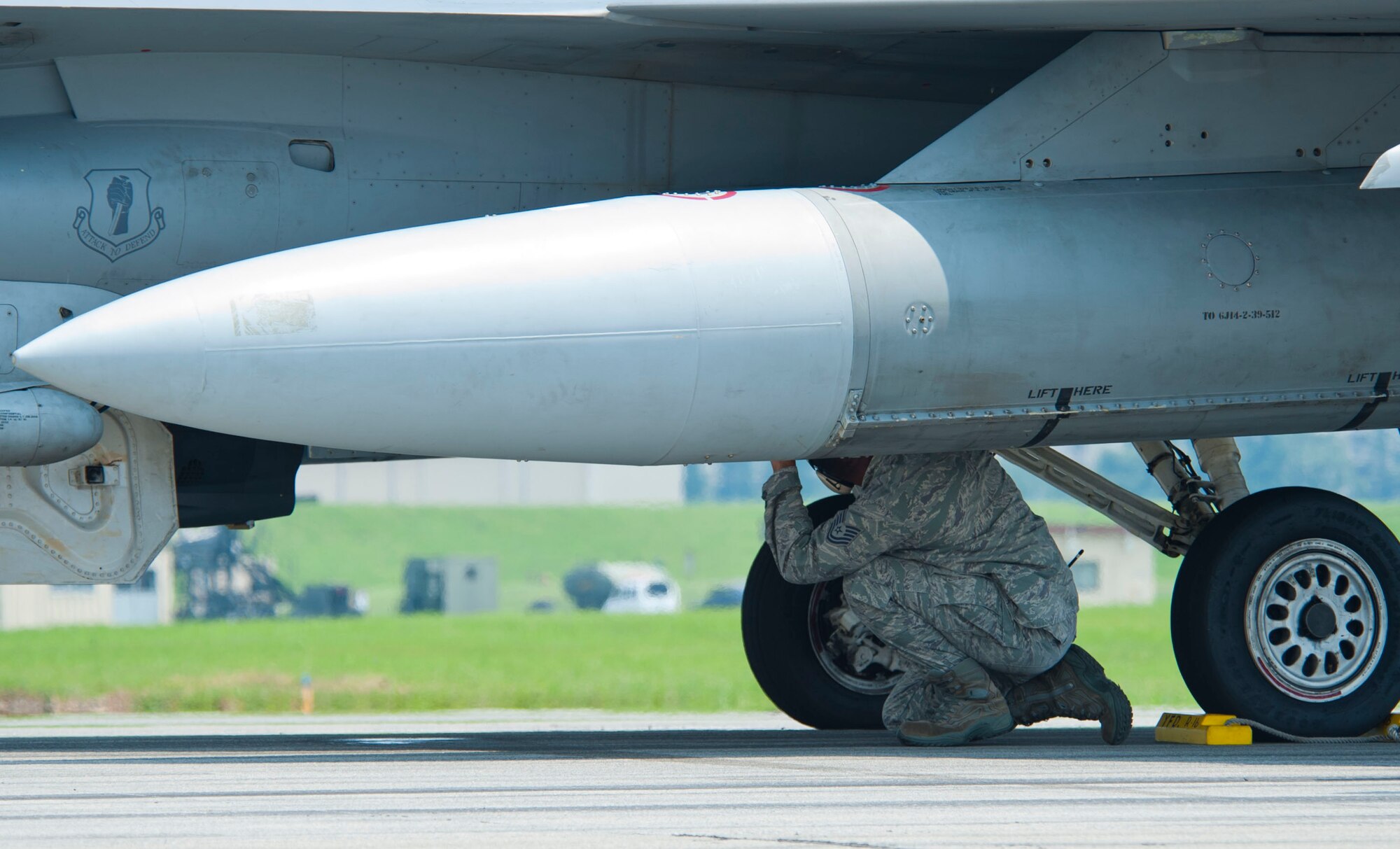 YOKOTA AIR BASE, Japan – An Airman checks on an F-16 Fighting Falcon after it completes testing of the emergency landing system at Yokota Air Base, Japan, July 10, 2013.  The two F-16’s from Misawa Air Base, Japan, were thoroughly checked immediately after the tests.  (U.S. Air Force photo by Airman 1st Class Soo C. Kim)