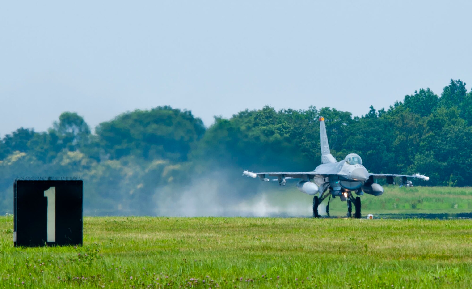 YOKOTA AIR BASE, Japan – An F-16 Fighting Falcon speeds over the runway at Yokota Air Base, Japan, July 10, 2013.  Two F-16’s from Misawa Air Base, Japan, participated in testing of the emergency landing system on Yokota’s flightline as part of annual tests of the mechanisms.  (U.S. Air Force photo by Airman 1st Class Soo C. Kim)