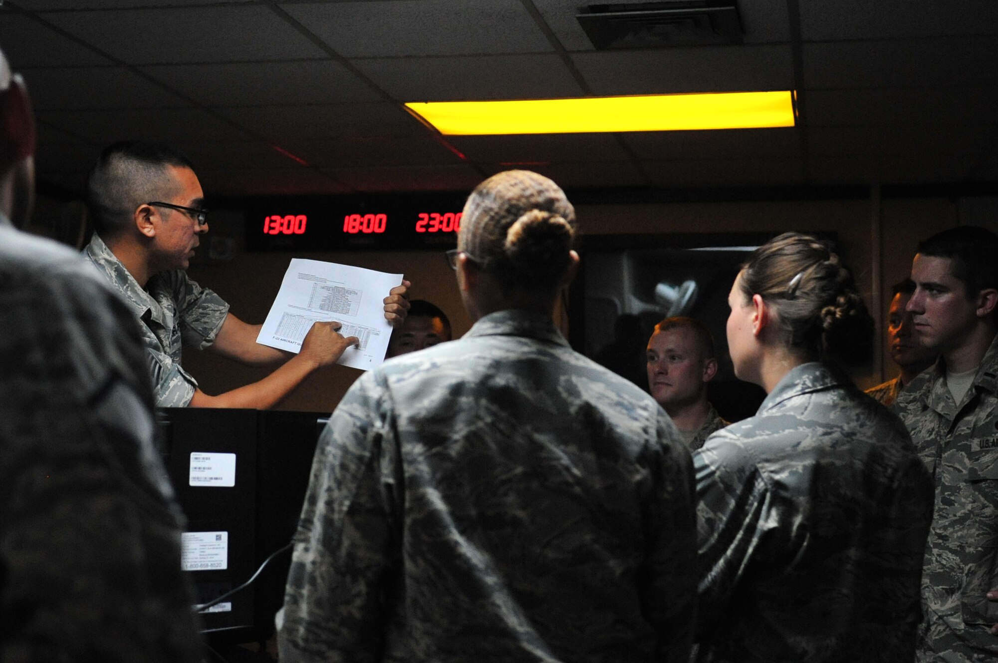 U.S. Air Force Staff Sgt. Daryl Perales, 18th Munitions Squadron lead controller, briefs members from the Logistics Officer Association on 18th MUNS operating procedures on Kadena Air Base, Japan, July 9, 2013. Composed of over 21 different logistic career fields, the Logistics Officer Association toured 18th MUNS and participated in a hands-on bomb build in order to gain a better understanding of the squadron and its roles and responsibilities. (U.S. Air Force photo by Senior Airman Amber E. N. Jacobs/Released)