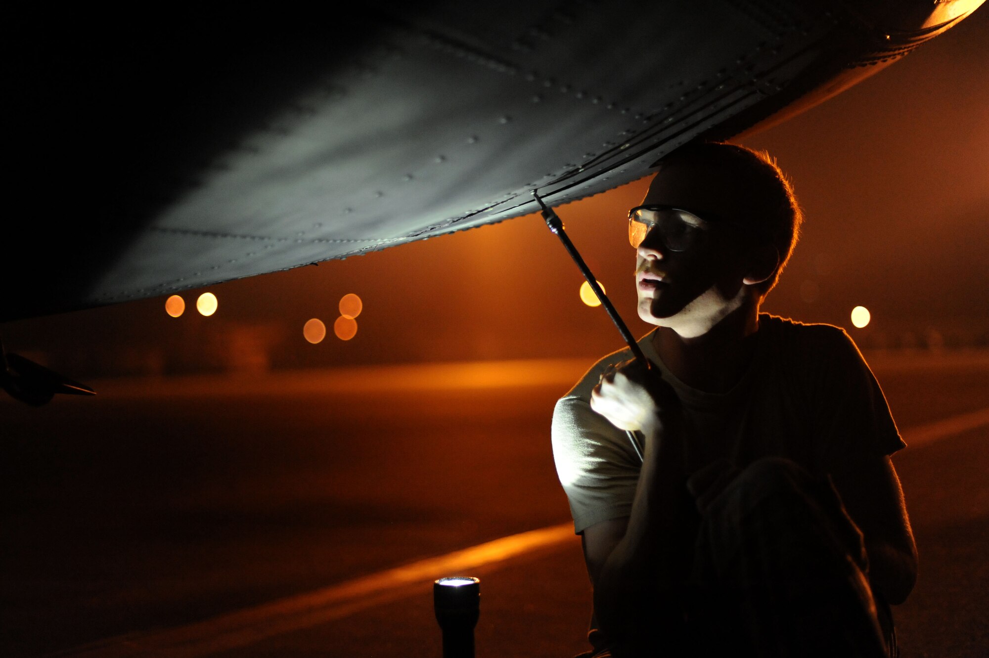 YOKOTA AIR BASE, Japan -- Staff Sgt. Witten Bolte, 374th Aircraft Maintenance Squadron crew chief, removes a screw from a C-130 Hercules on July 10, 2013 at Yokota Air Base, Japan.  It is crucial that every part is accounted for on the flight line even if it's as miniscule as a screw.(U.S. Air Force photo by Airman 1st Class Meagan Schutter)