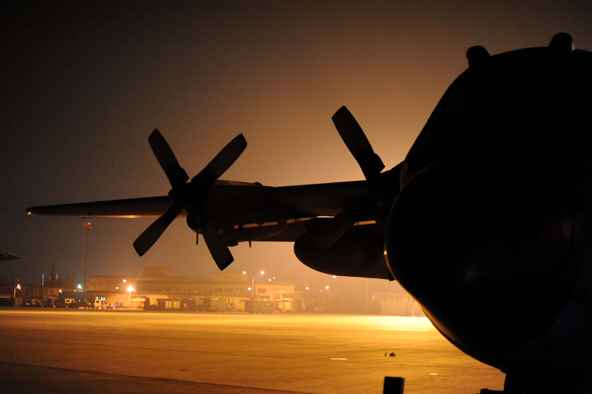 YOKOTA AIR BASE, Japan -- A C-130 Hercules rests on the taxiway while being worked on July 10, 2013 at Yokota Air Base, Japan.  Crew chiefs are not the only ones that work on the aircraft; there are many other groups that help service the aircraft. (U.S. Air Force photo by Airman 1st Class Meagan Schutter)