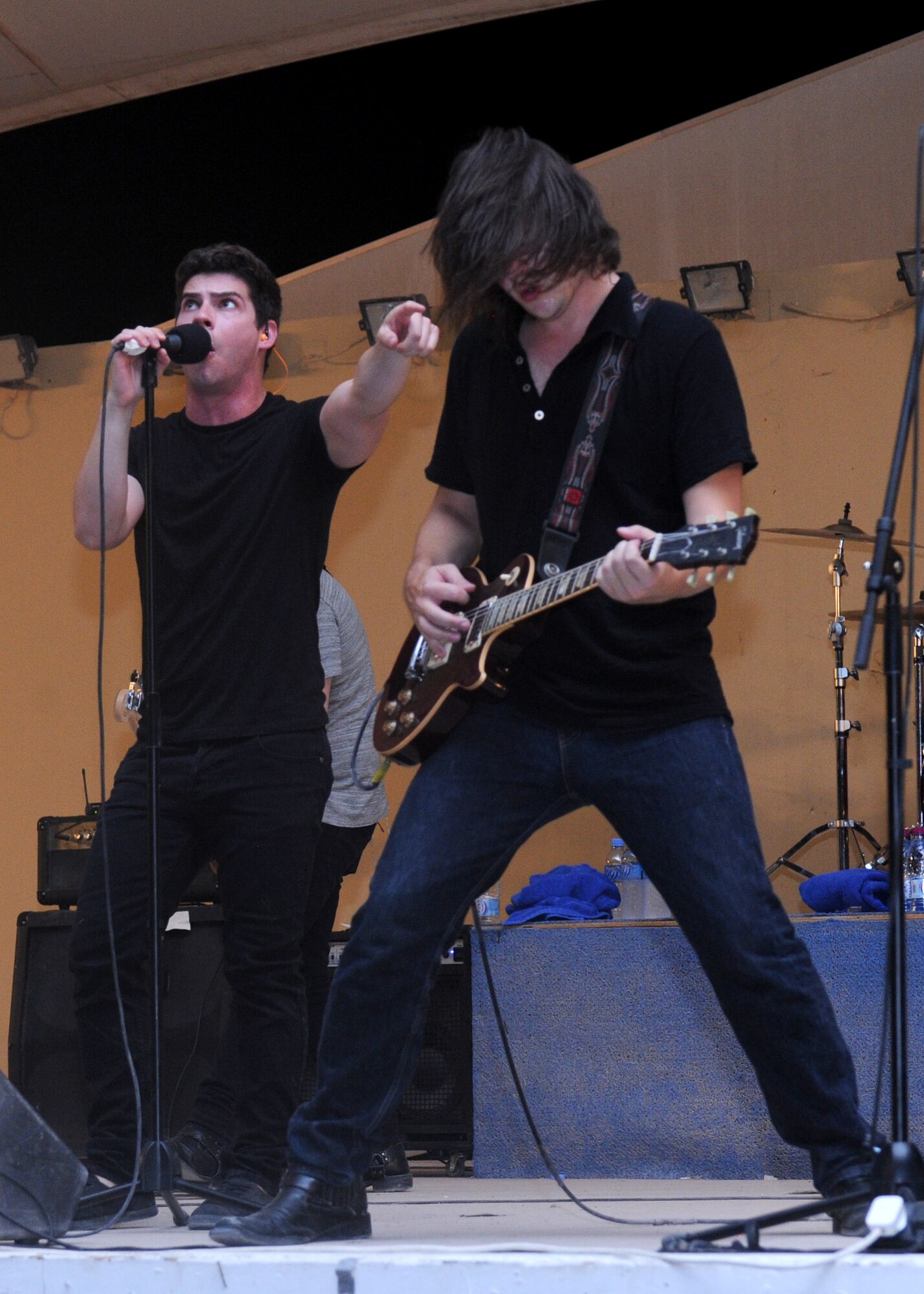 Andy Brooks, Transmit Now vocalist cues Kevin Parrow, Transmit Now guitarist, to begin a solo during an Armed Forces Entertainment Tour across the region, July 7, 2013 at the 379th Air Expeditionary Wing in Southwest Asia. AFE is the official Department of Defense agency for providing entertainment to U.S. military personnel overseas. (U.S. Air Force photo/ Senior Airman Bahja J. Jones) 

