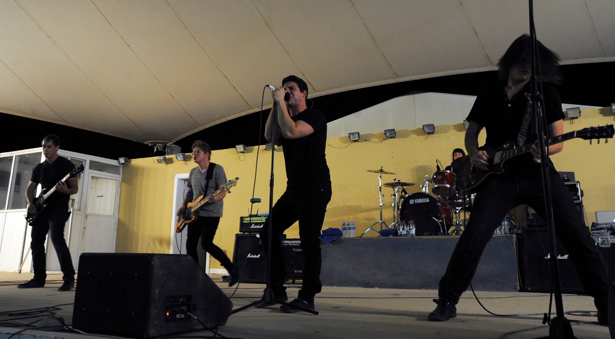 Alternative, pop-rock band, Transmit Now, performs during an Armed Forces Entertainment Tour across the region, July 7, 2013 at the 379th Air Expeditionary Wing in Southwest Asia. The Orlando, Fla., band staked their claim to fame after winning an online “Battle of the Bands” contest, resulting in their first live performance in 2008. (U.S. Air Force photo/ Senior Airman Bahja J. Jones)