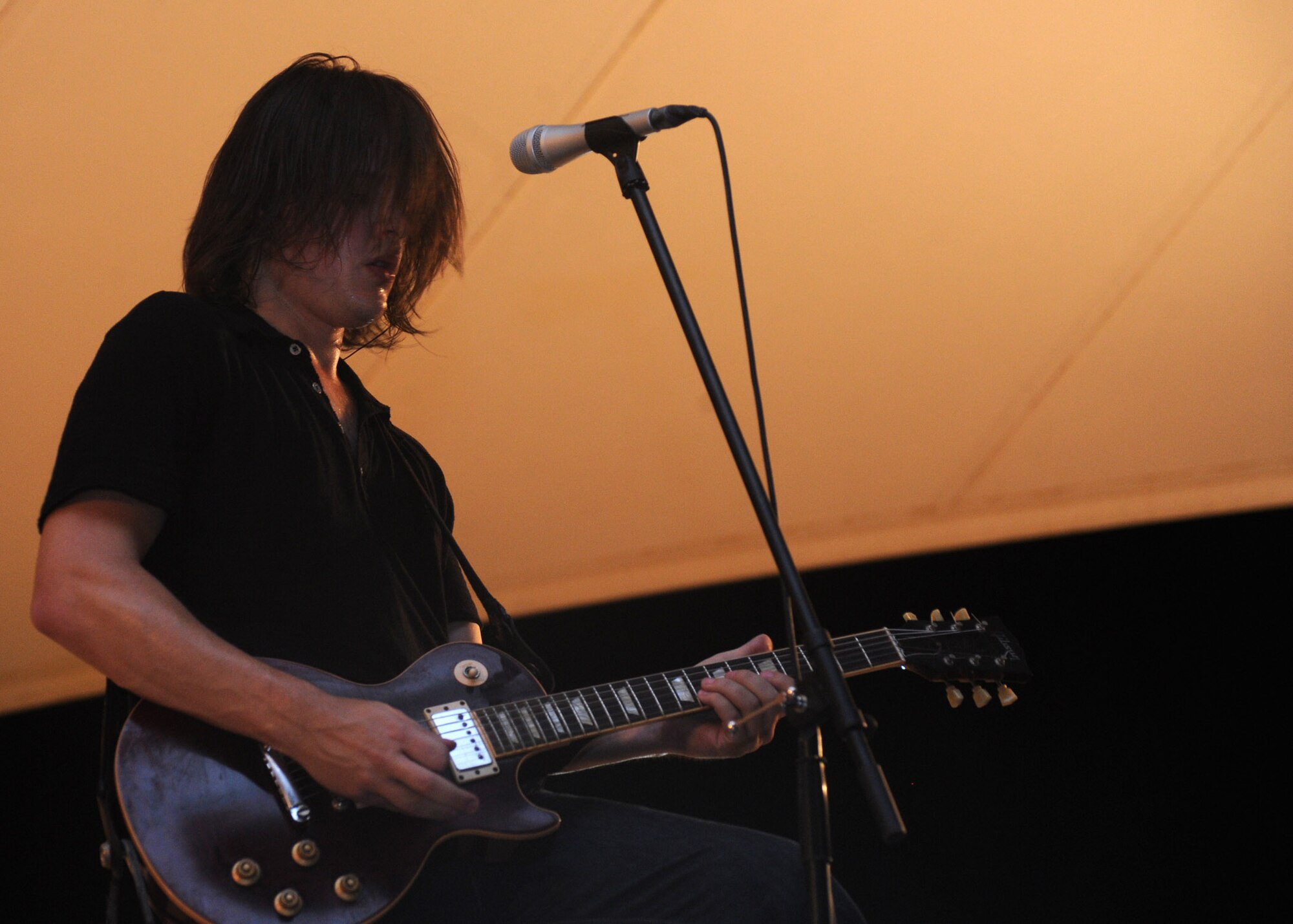 Kevin Parrow, Transmit Now guitarist, performs a solo during an Armed Forces Entertainment Tour across the region, July 7, 2013 at the 379th Air Expeditionary Wing in Southwest Asia. AFE is the official Department of Defense agency for providing entertainment to U.S. military personnel overseas. (U.S. Air Force photo/ Senior Airman Bahja J. Jones) 