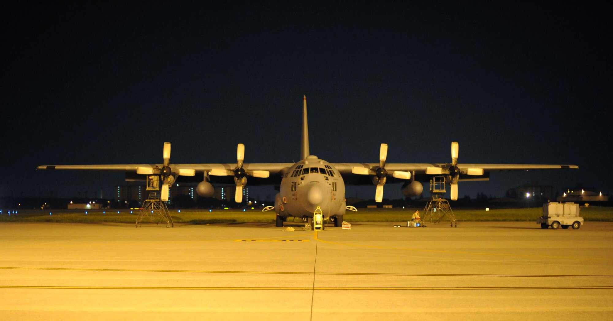 YOKOTA AIR BASE, Japan -- A C-130 Hercules rests on the taxiway while getting it's engines serviced on July 10,2013 at Yokota Air Base, Japan.  Crew chiefs are not the only ones that work on the aircraft; engine technicians play a big part in making the plane serviceable. (U.S. Air Force photo by Airman 1st Class Meagan Schutter)