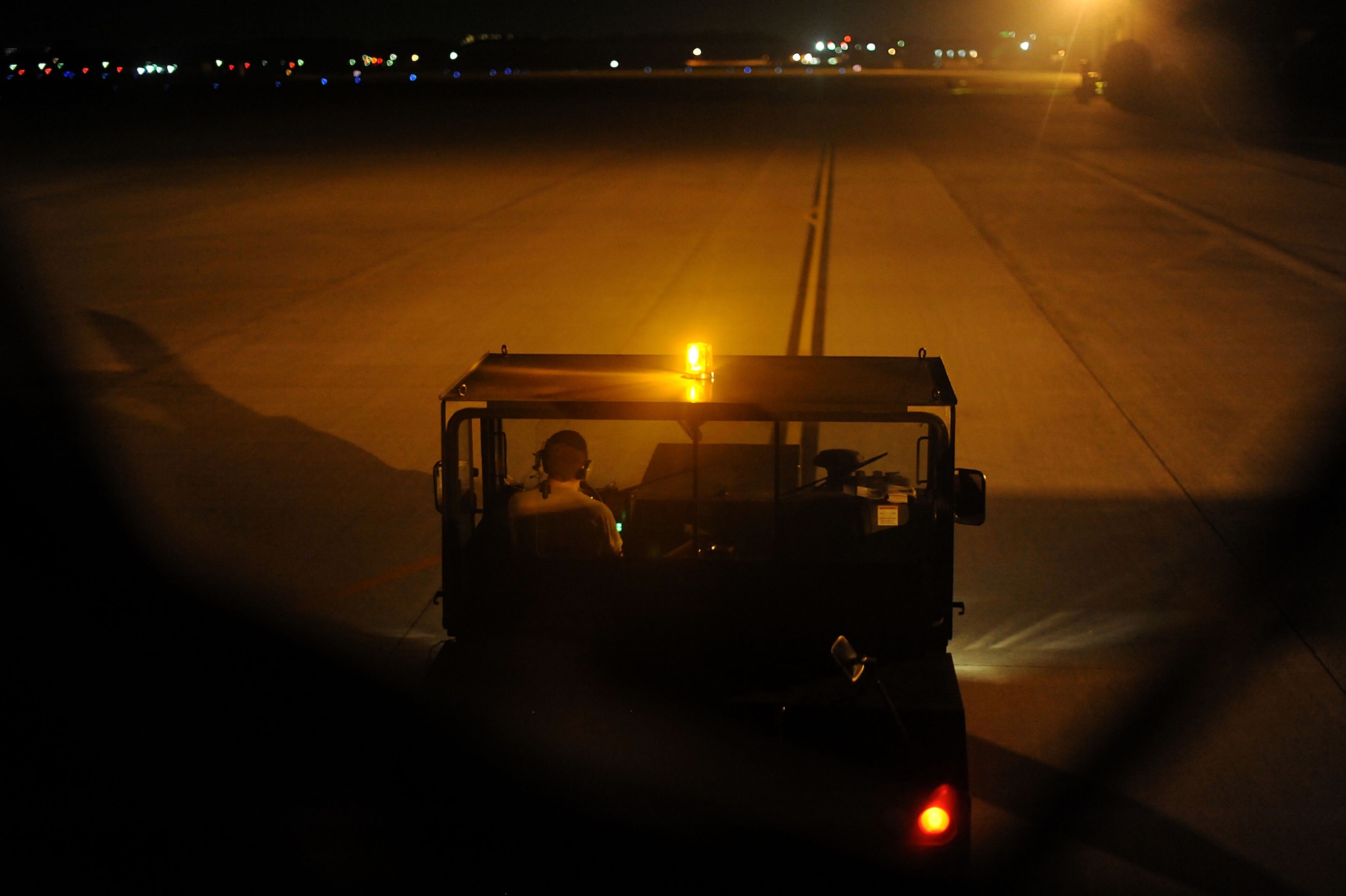 YOKOTA AIR BASE, Japan -- Airman 1st Class Andrew Thornton, 374th Aircraft Maintenance Squadron crew chief, tows a C-130 Hercules down the taxiway on July 10, 2013 at Yokota Air Base, Japan.  The aircraft gets towed to the wash rack where it will be cleaned by assigned civilians. (U.S. Air Force photo by Airman 1st Class Meagan Schutter)