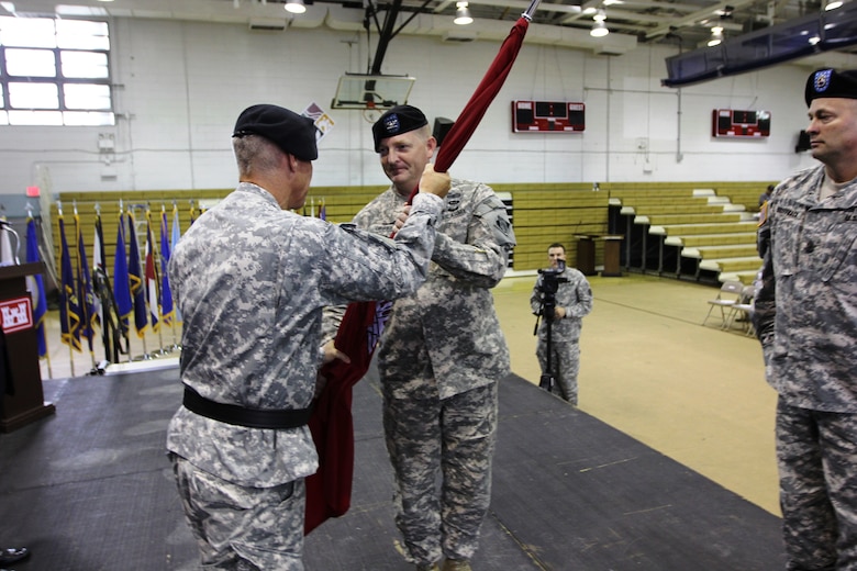 Brig. Gen. Richard L. Stevens (left), Commander, U.S. Army Corps of Engineers, Pacific Ocean Division, passes the Engineer Colors to Col. Bryan S. Green (right), Far East District incoming commander, during a ceremony on U.S. Armcy Garrison Yongsan July 11. 