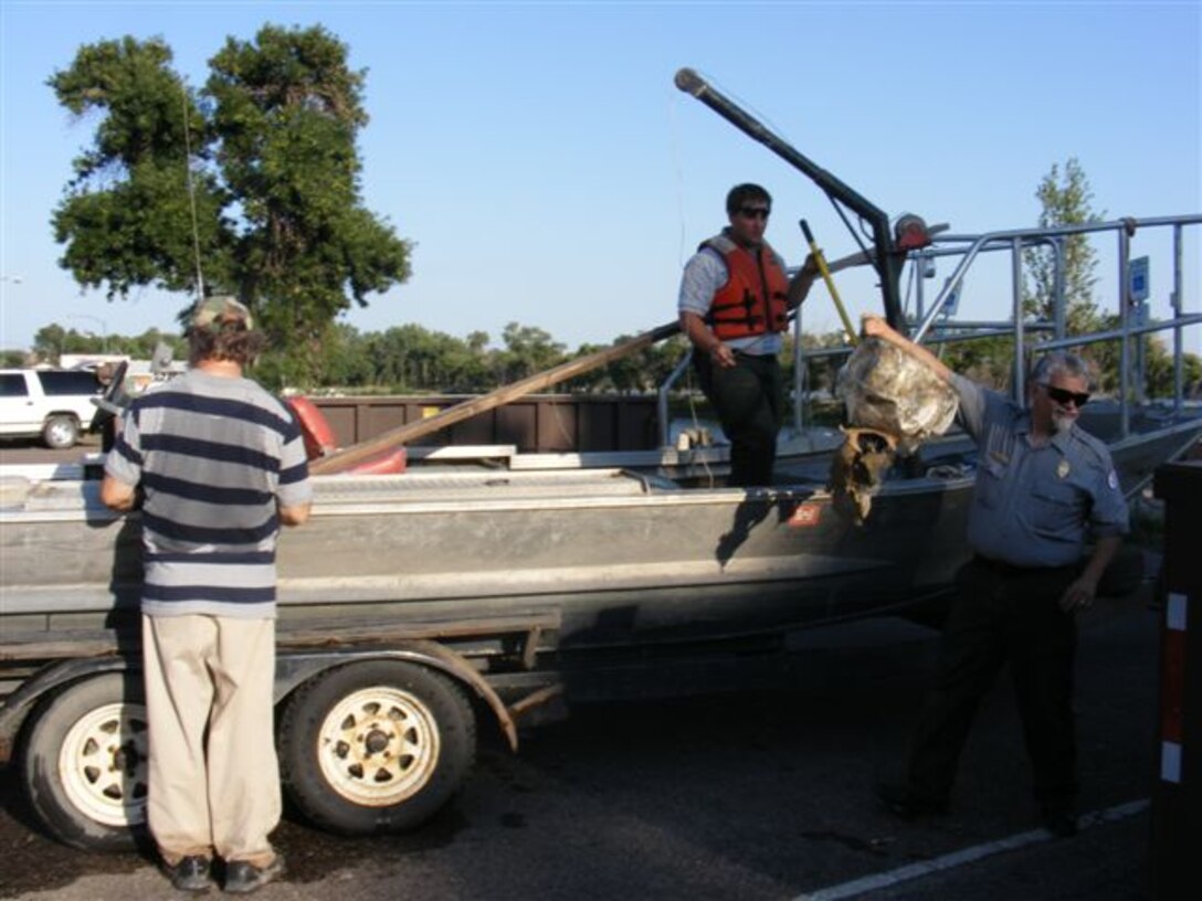 More than 4,000 pounds, or two tons, of trash and debris was collected during the annual Missouri River/Lake Sharpe Clean up Wednesday, July 10, 2013. Corps employees Mike Stanley and Phil Sheffield help with cleanup activities along the river in Pierre-Fort Pierre, S.D.