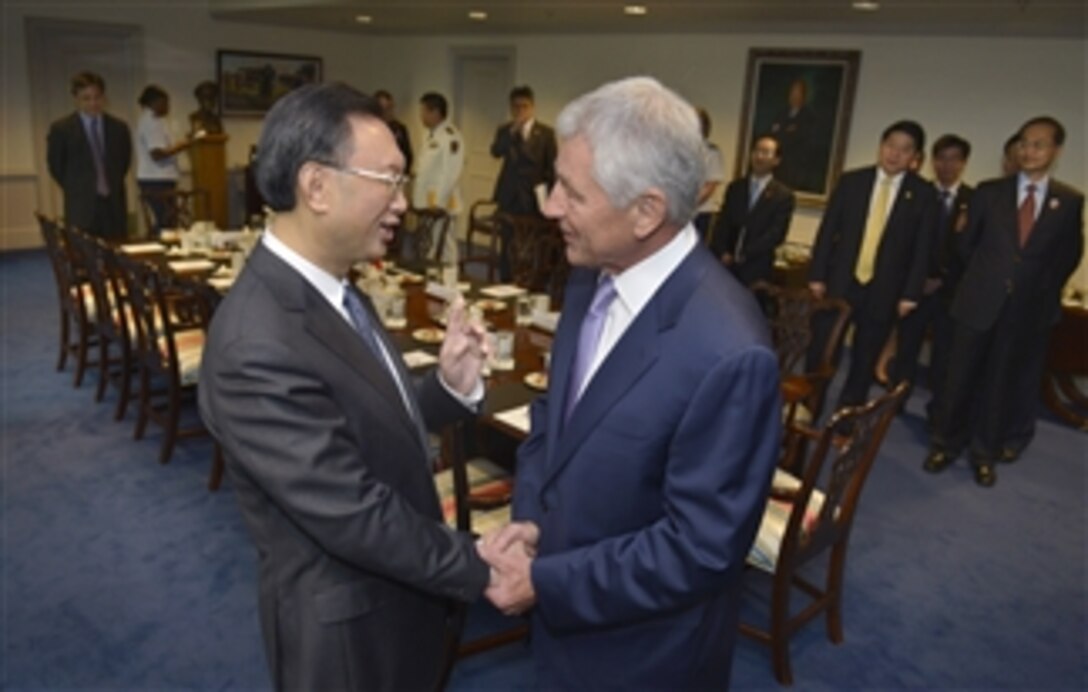 Secretary of Defense Chuck Hagel, right, offers a warm welcome to Chinese State Councilor Yang Jiechi as they prepare to sit down for a meeting in the Pentagon in Arlington, Va., on July 12, 2013.  Hagel and Yang have a shared history and friendship that stretches back many years to their previous positions in government service.  