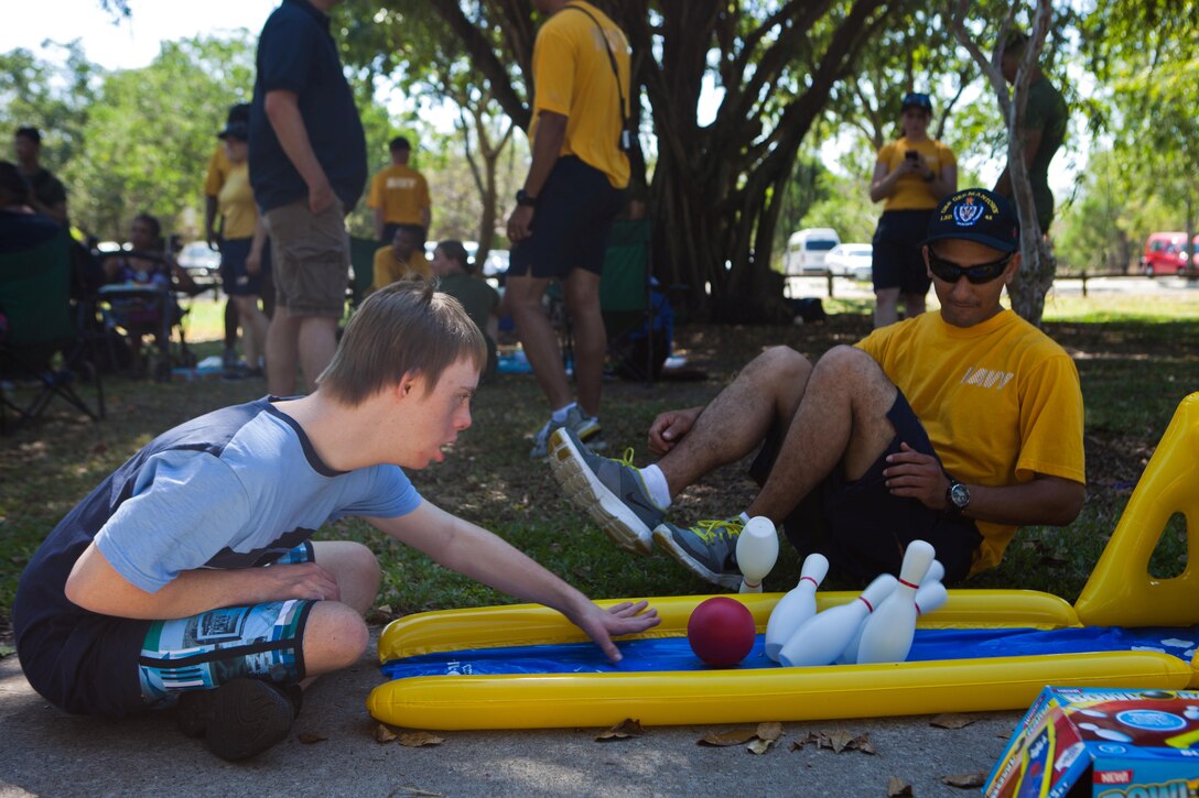 Seaman Alexis Valleonldan, an undesignated seaman with USS Germantown and native of Clarksville, Tenn., helps a child from the Life Without Barriers organization play a bowling game during a visit at the Lake Alexander park, July 6. The Marines and Sailors of the 31st Marine Expeditionary Unit and USS Germantown spent a day of liberty playing musical instruments, dancing, playing board games and making bead necklaces with disabled men, women, and children. The 31st MEU is the only continuously forward-deployed MEU and is the Marine Corps’ force in readiness in the Asia-Pacific region.
