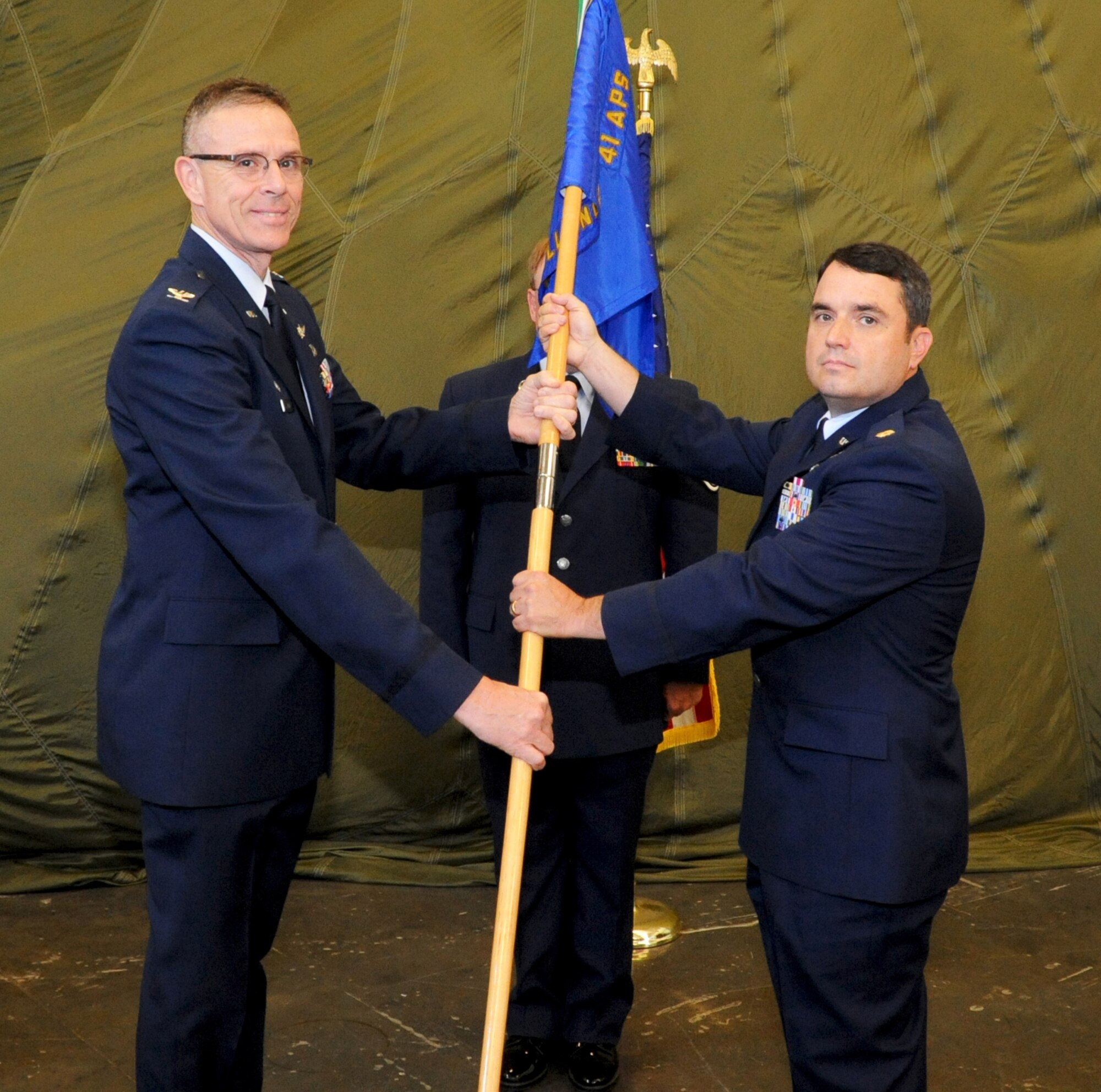 Col. Kevin Riley, 403rd Support Group commander, passes the 41st Aerial Port Squadron flag to Maj. Joseph Terry during an assumption of command ceremony held at the 41st APS building, Keesler Air Force Base, Miss., July 13, 2013. Terry assumed command of the 41st APS. (U.S. Air Force photo/Senior Airman Chris DeBlanc)