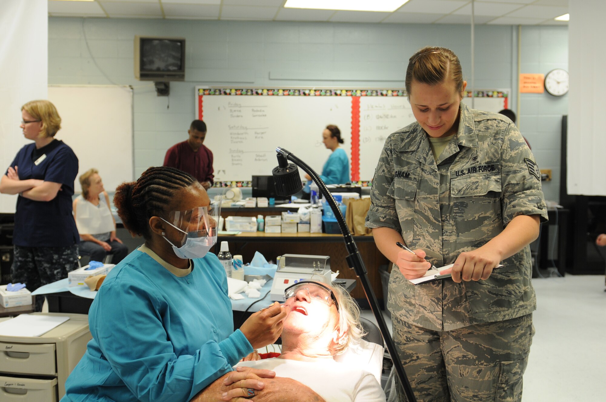 Air Force Maj. Tiffany Harper, a dentist with the 192nd Fighter Wing, Joint Base Langley-Eustis, Va. and Air Force Staff Sgt. Rebecca Bingham, a medical service technician discuss dental procedures with Wayne Alexander, June 11, 2013 at ‘Hope of Martin’ Innovative Readiness Training held at Martin Middle School in Martin, Tenn. (Air Force Photo by Tech. Sgt. Meghan Skrepenski, Virginia Air National Guard Public Affairs)