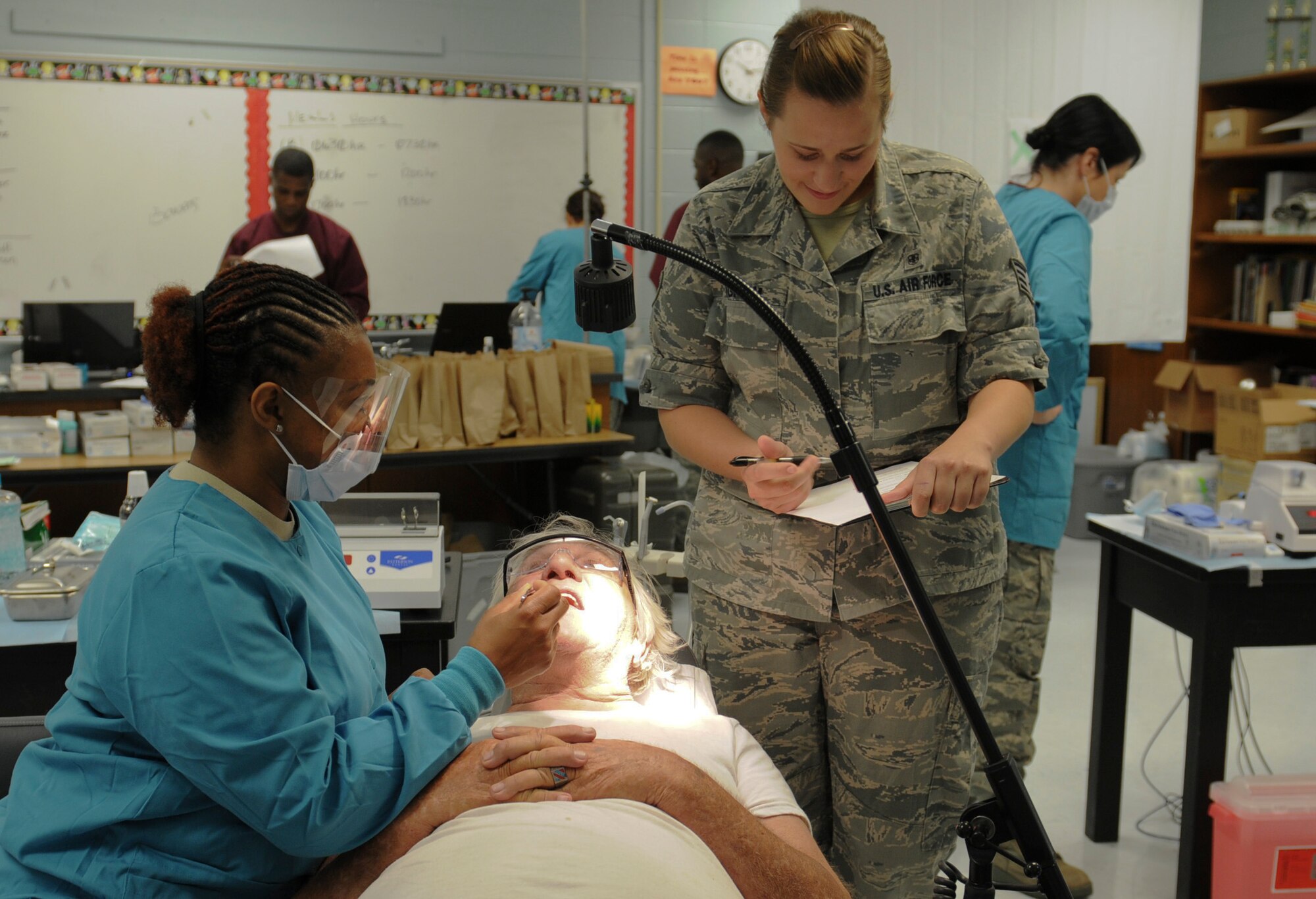Air Force Maj. Tiffany Harper, a dentist with the 192nd Fighter Wing, Joint Base Langley-Eustis, Va. and Air Force Staff Sgt. Rebecca Bingham, a medical service technician discuss dental procedures with Wayne Alexander, June 11, 2013 at ‘Hope of Martin’ Innovative Readiness Training held at Martin Middle School in Martin, Tenn. (Air Force Photo by Tech. Sgt. Meghan Skrepenski, Virginia Air National Guard Public Affairs)