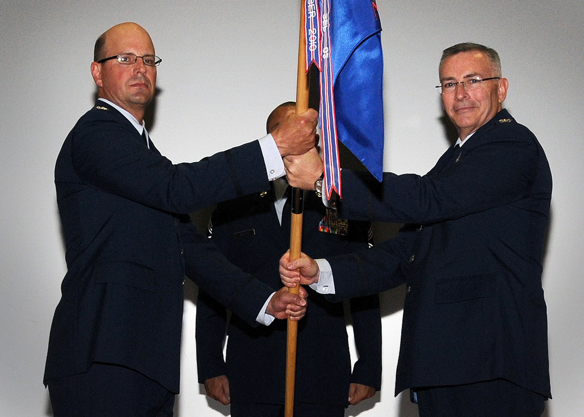 512th Airlift Wing Commander, Col. Raymond Kozak (left), officiates 512th Operations Group assumption of command ceremony for Col. Jonathan M. Philebaum at the base theater, Dover Air Force Base, Del., July 13, 2013. Philebaum previously served as the 730th Air Mobility Training Squadron Commander, Altus AFB, Okla. (U.S. Air Force photo/Senior Airman Erika Brooke)
